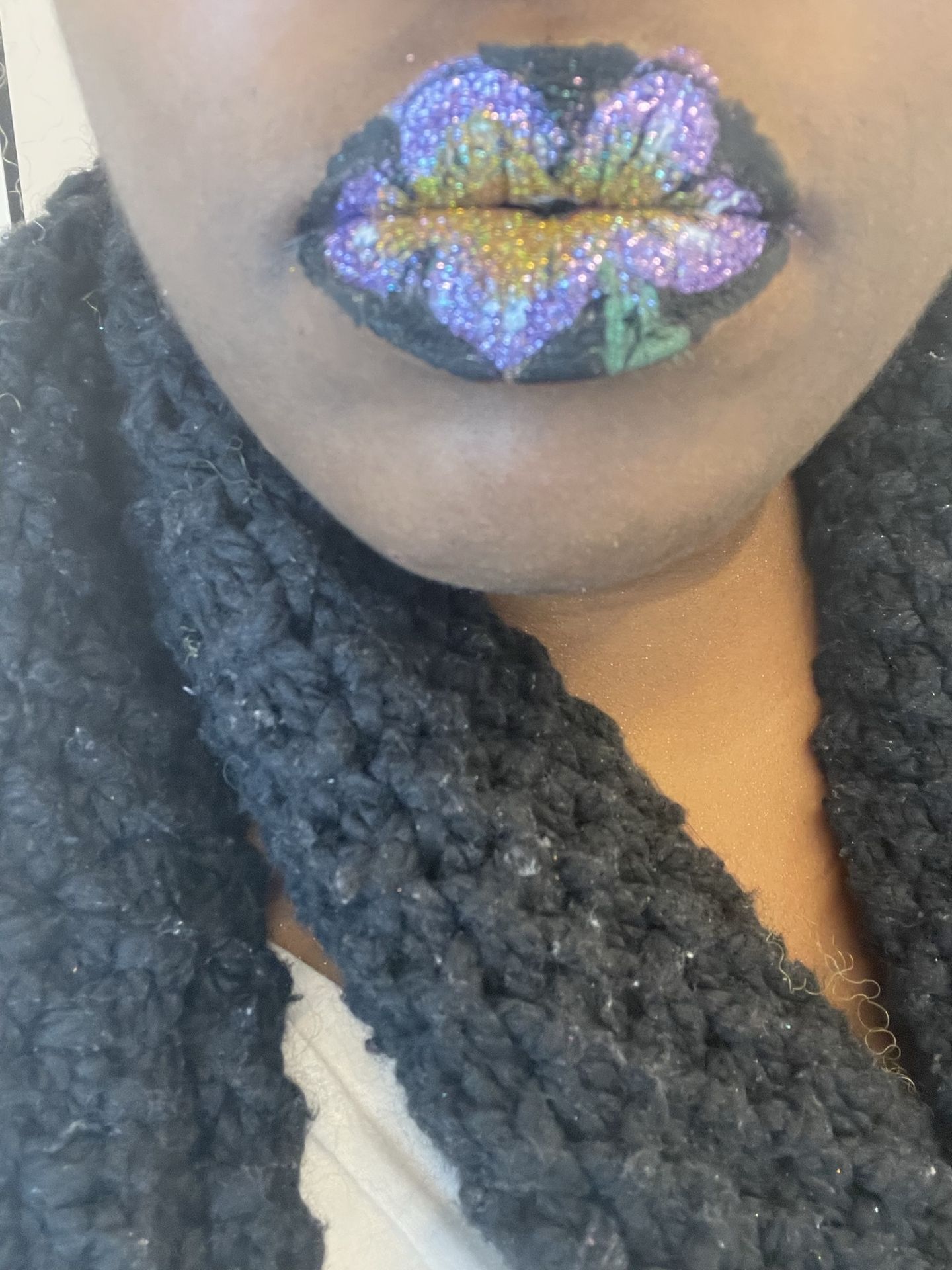 Black woman with light blue hair and frosted blue lip art, close-up beauty portrait with cool-tone editorial makeup