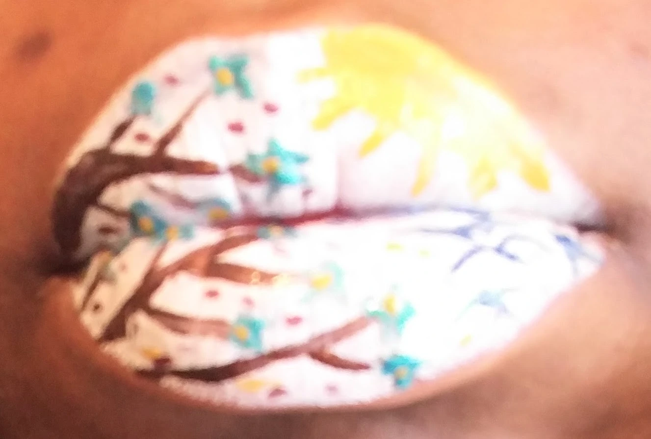 Extreme close-up of pastel rainbow marble-pattern lip art