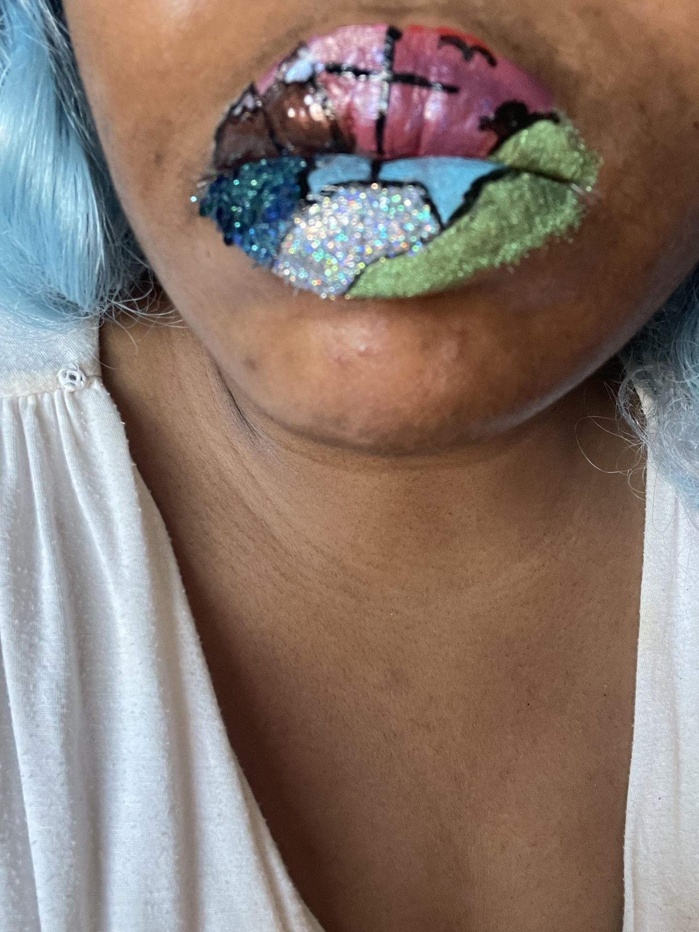 Black woman with teal glitter lip art, close-up portrait showcasing sparkling texture and bold color in creative makeup design