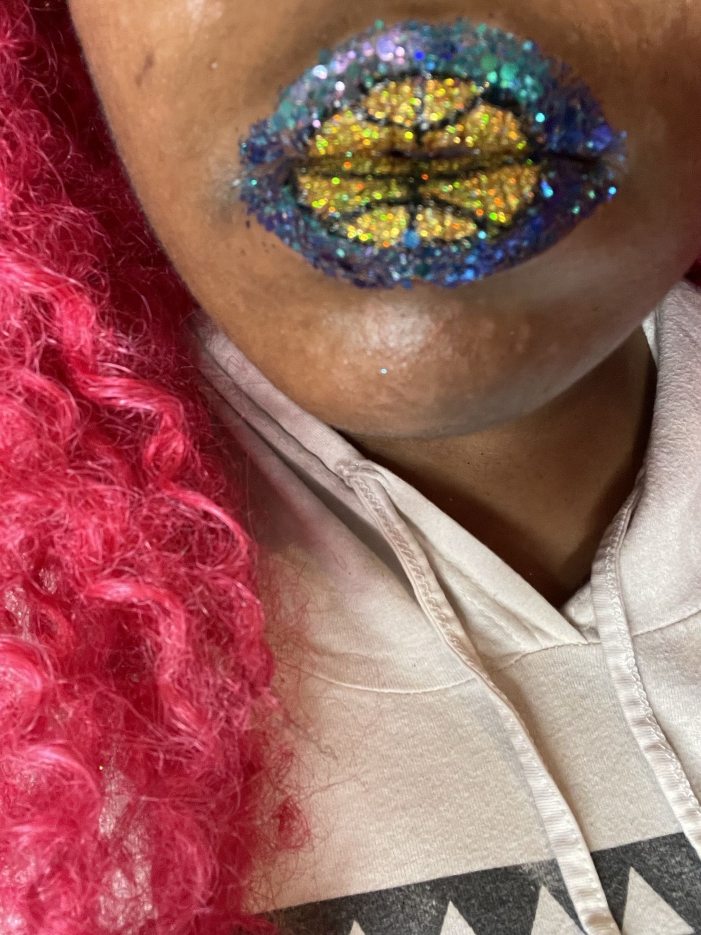 Black woman with gold and blue crystal lip art, close-up beauty image featuring high-detail gemstone texture and artistic cosmetic styling