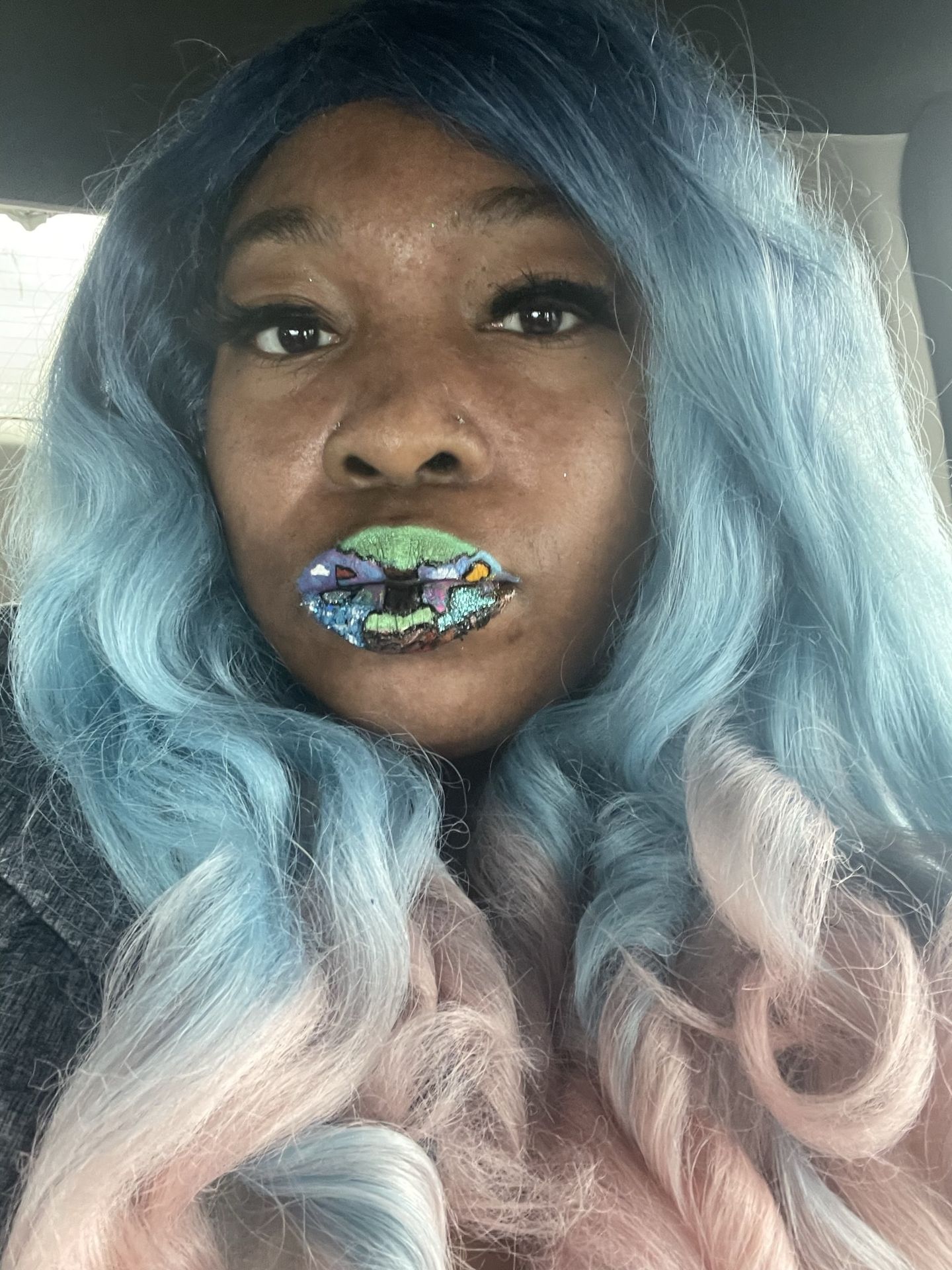 Black woman with pastel blue wig and silver crystal lips, luminous artistic makeup photography.