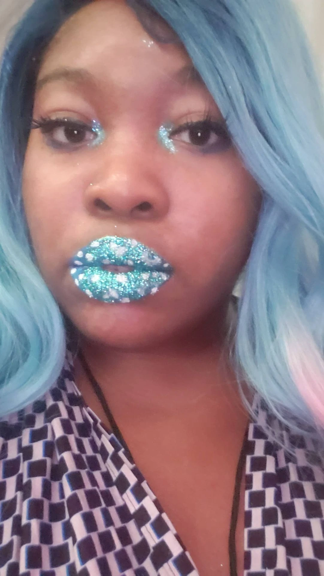 Woman with pale blue hair and icy blue glitter lips