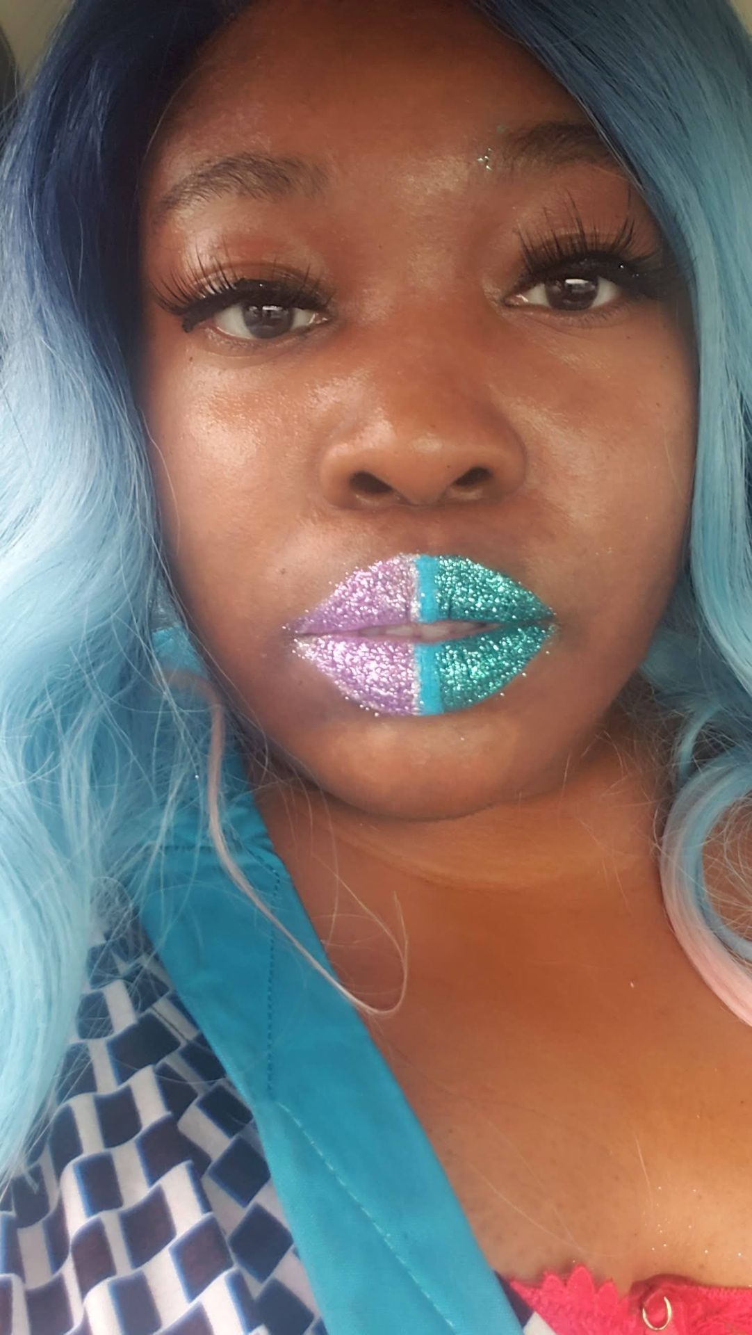 Woman with aqua hair and silver-blue crystal lip design