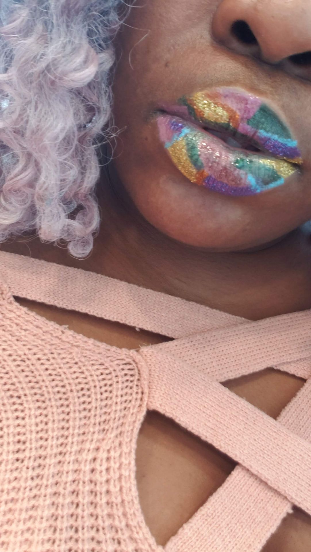 Side view of rainbow crystal lip design with soft curl framing the face