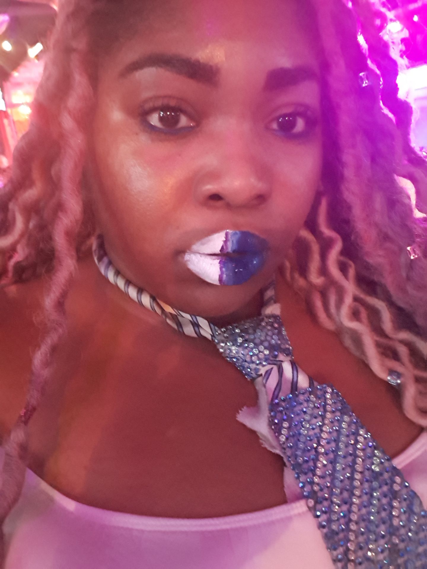 Woman with pink-purple lighting and chrome violet lipstick