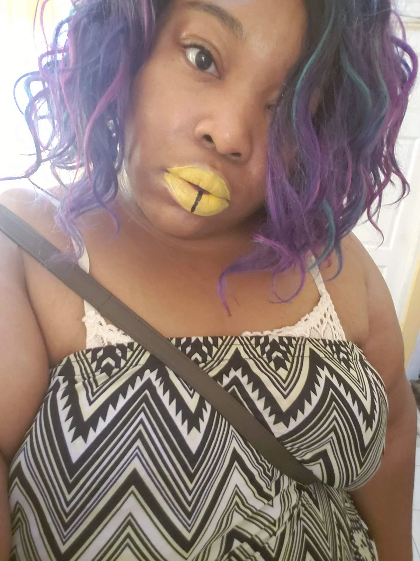 Woman with purple curls and matte gold lipstick