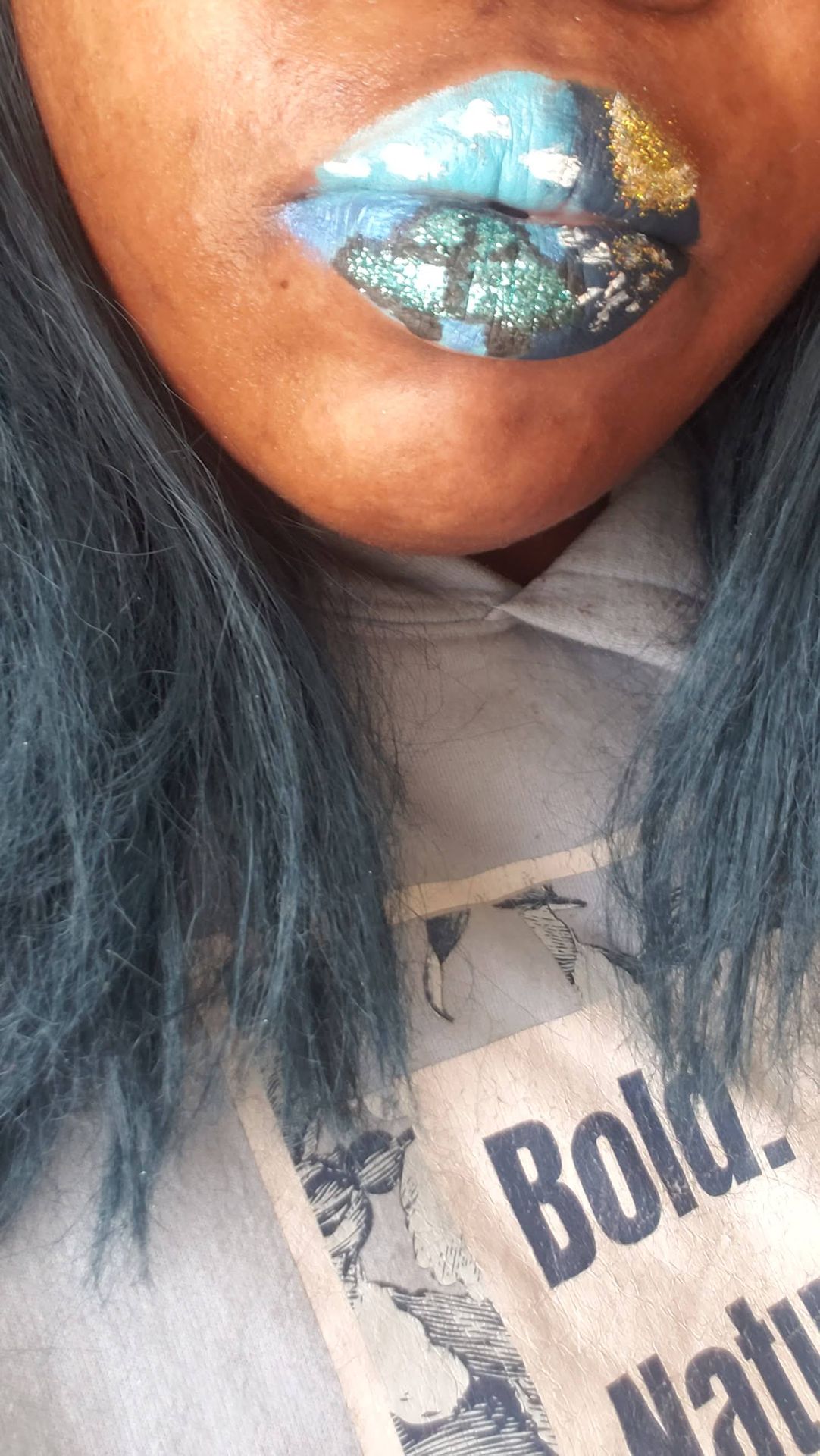 Close-up of woman with long black hair wearing satin nude-brown lipstick