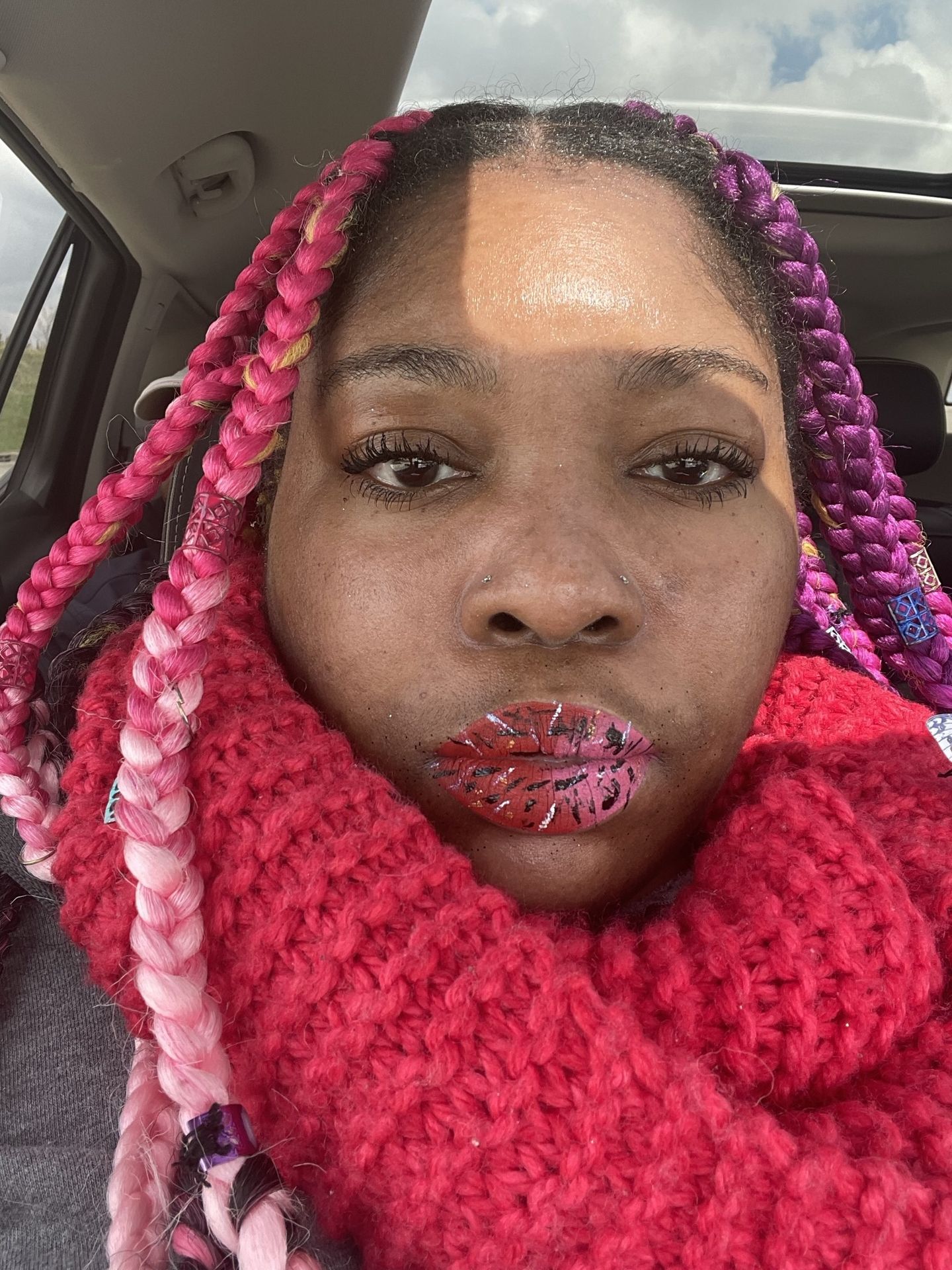 “Portrait of woman with pink braids and red lipstick.”