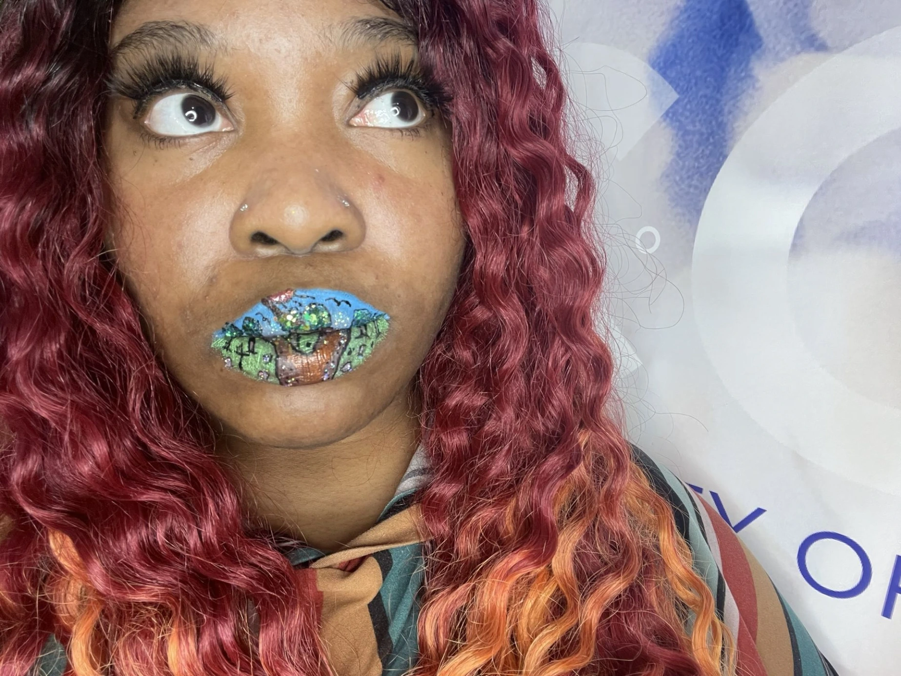 Black woman with dark hair and blue-silver glitter lips, close-up portrait with bold sparkle and editorial lighting