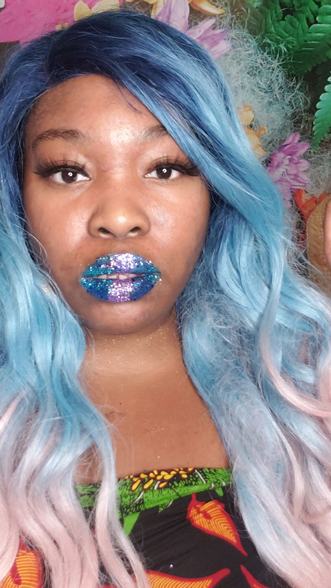 Woman with light blue waves wearing deep sapphire shimmer lipstick