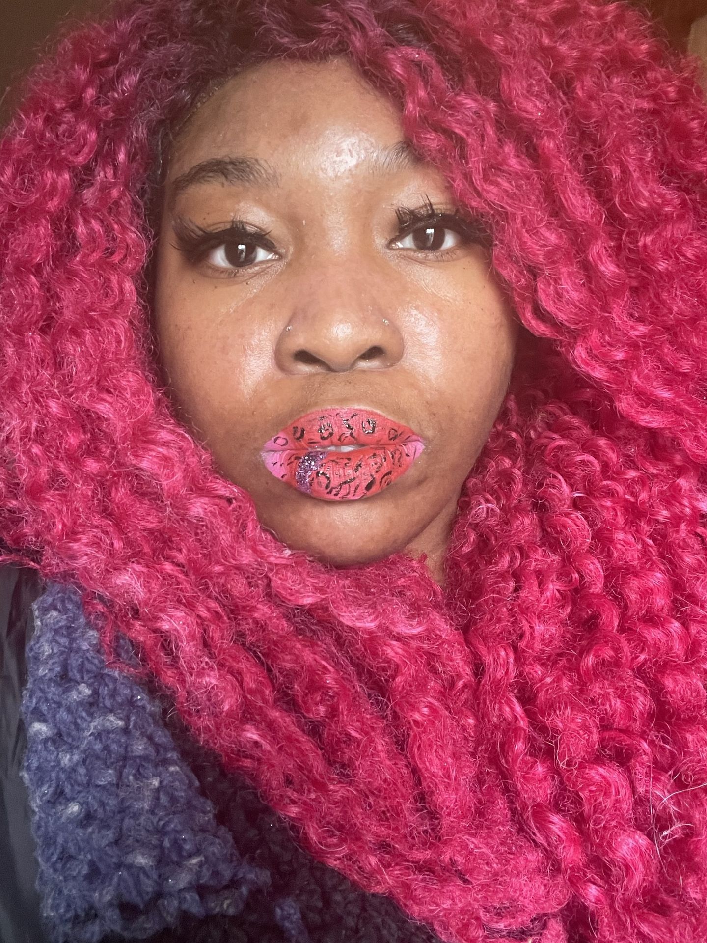 “Portrait of woman with pink braids and glossy red lipstick.”