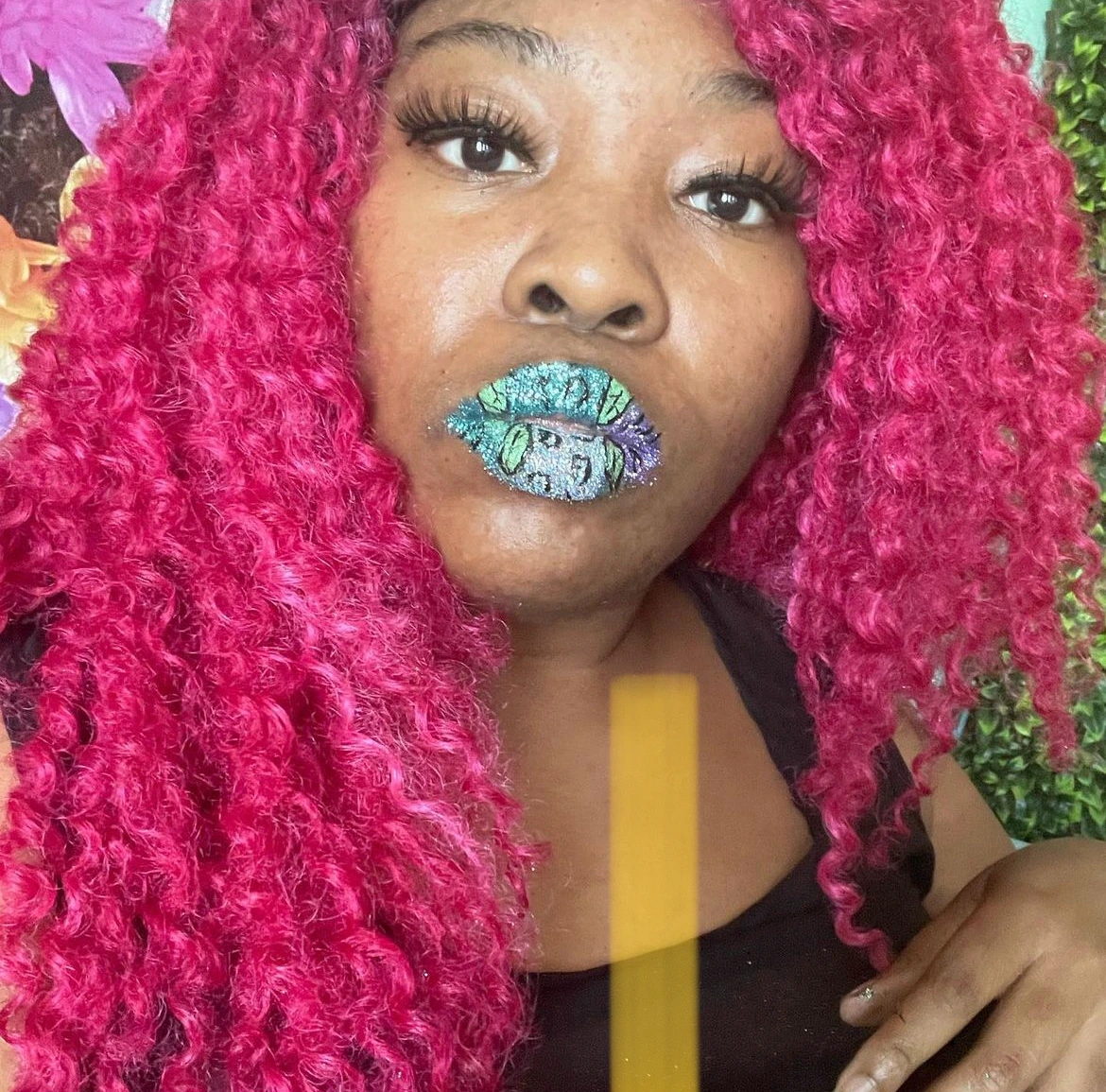 Black woman with silver curls and cobalt metallic lipstick