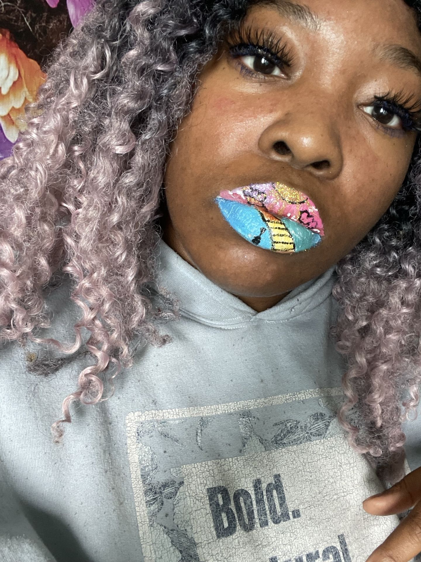 “Close-up of woman with silver hair and rainbow glitter lips.”