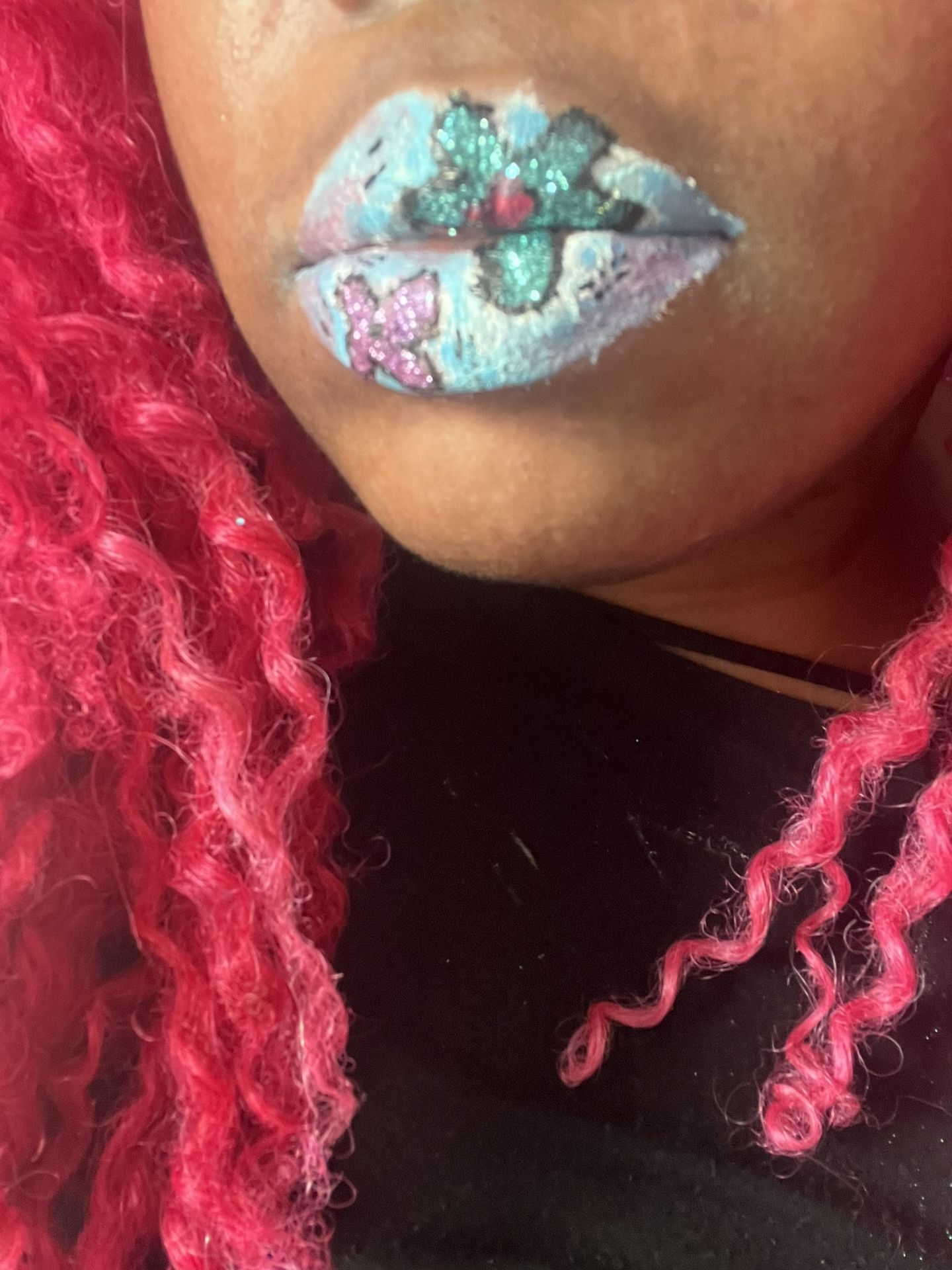 Close-up of pink locs framing silver and aqua crystal lip design