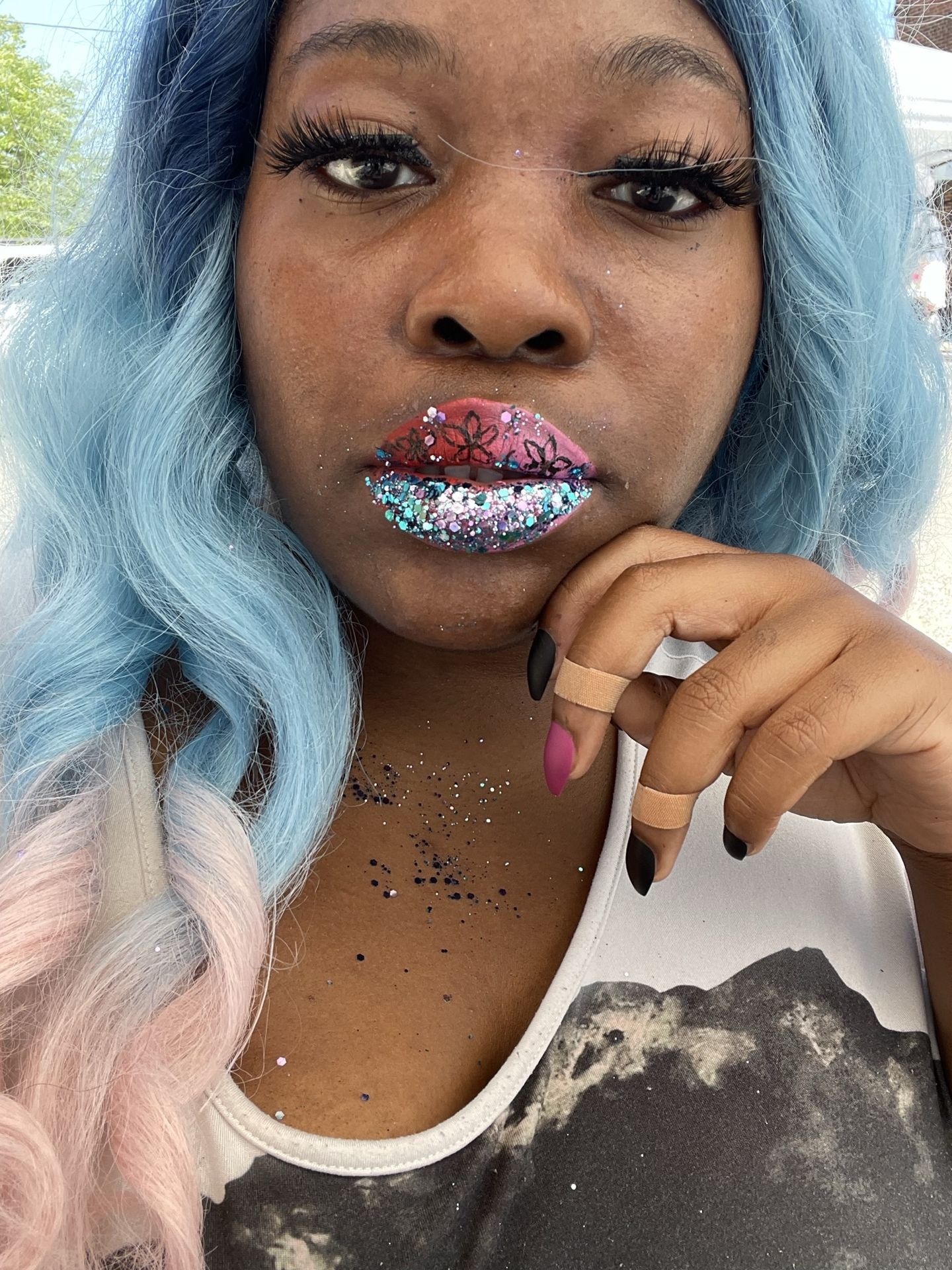 Woman with ice-blue hair touching her chin, wearing rose crystal lips