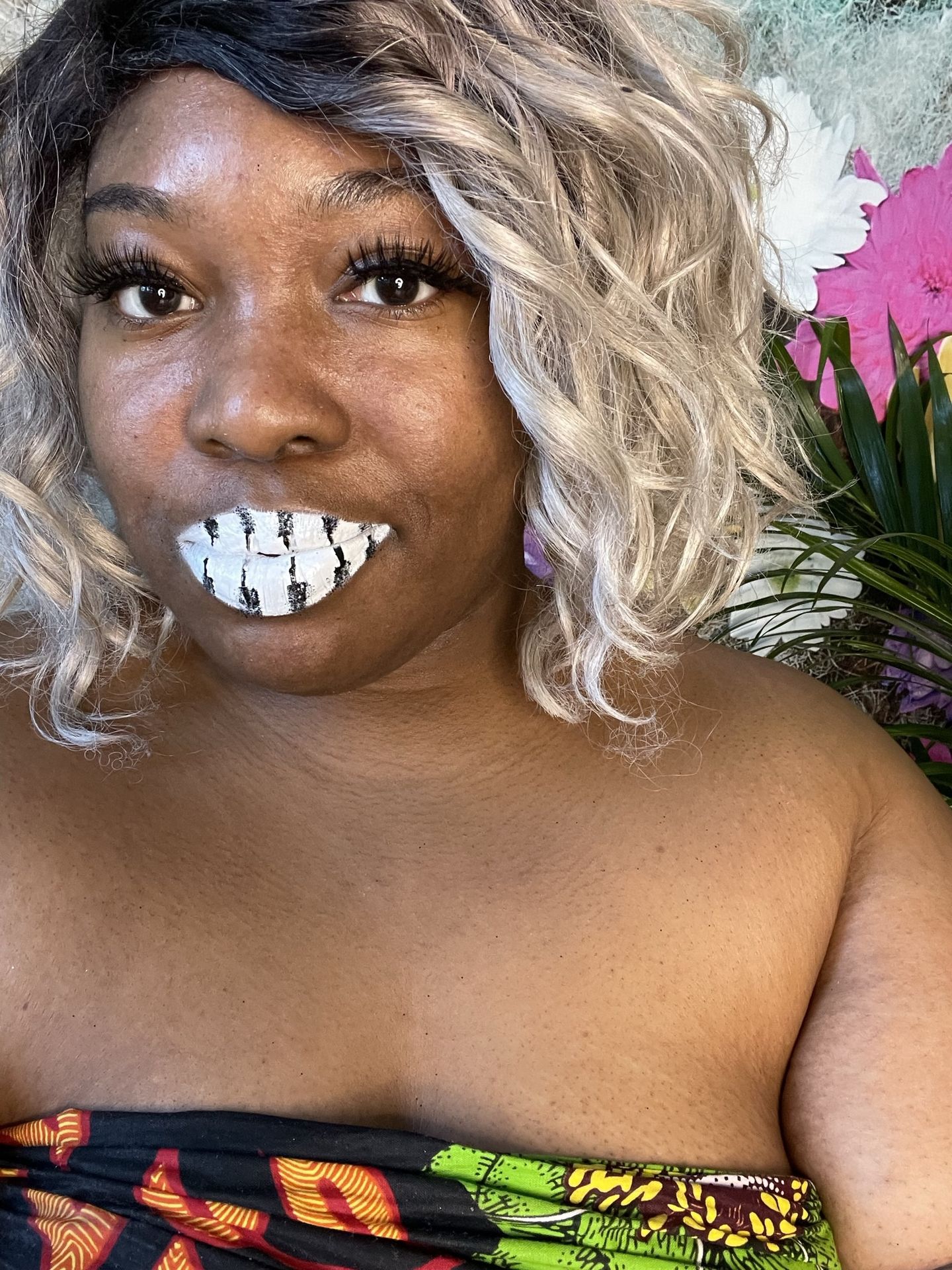 “Portrait of woman with curly blonde hair and silver glitter lips.”