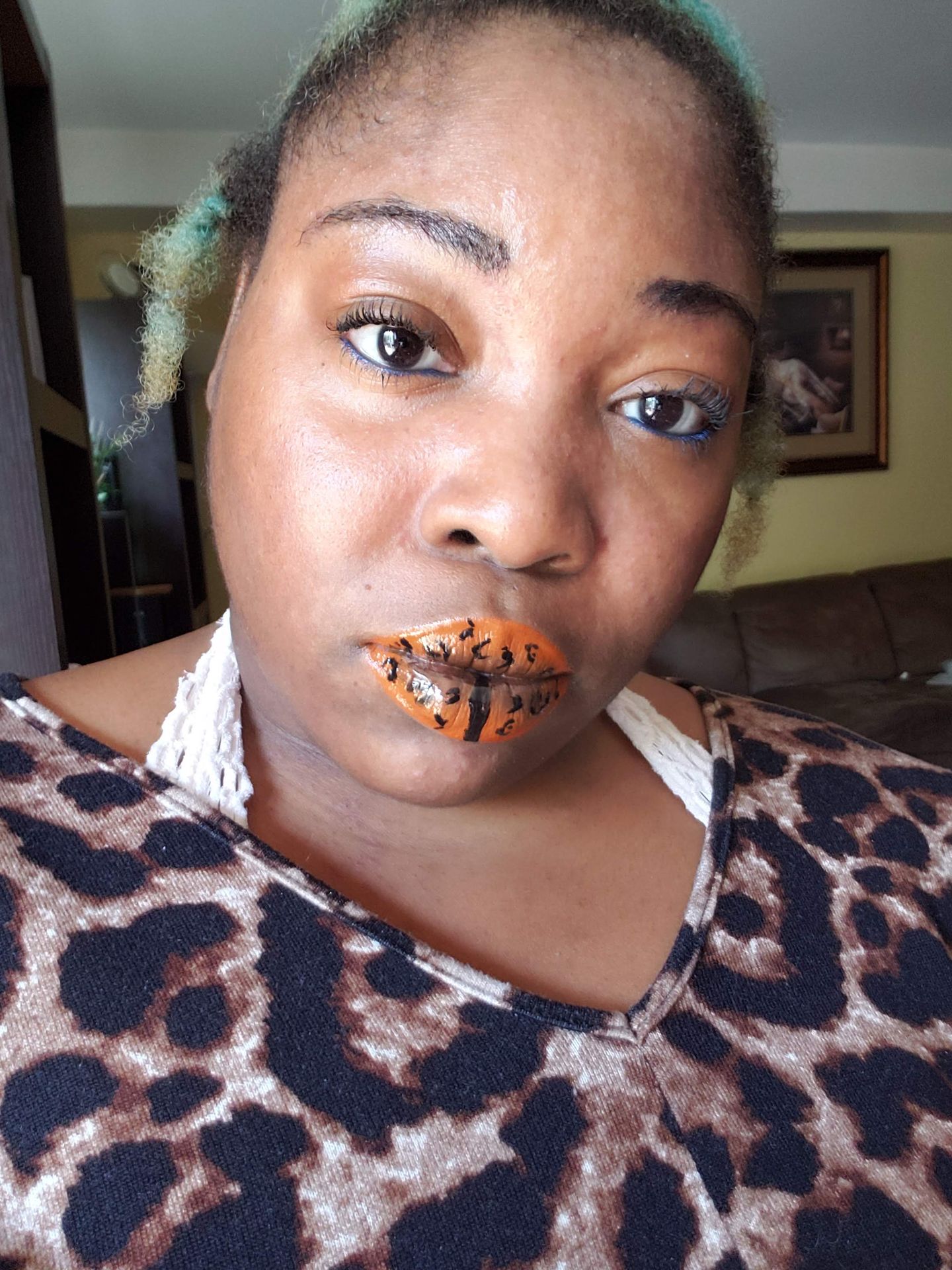 Woman in leopard print top wearing copper and teal foil lip design