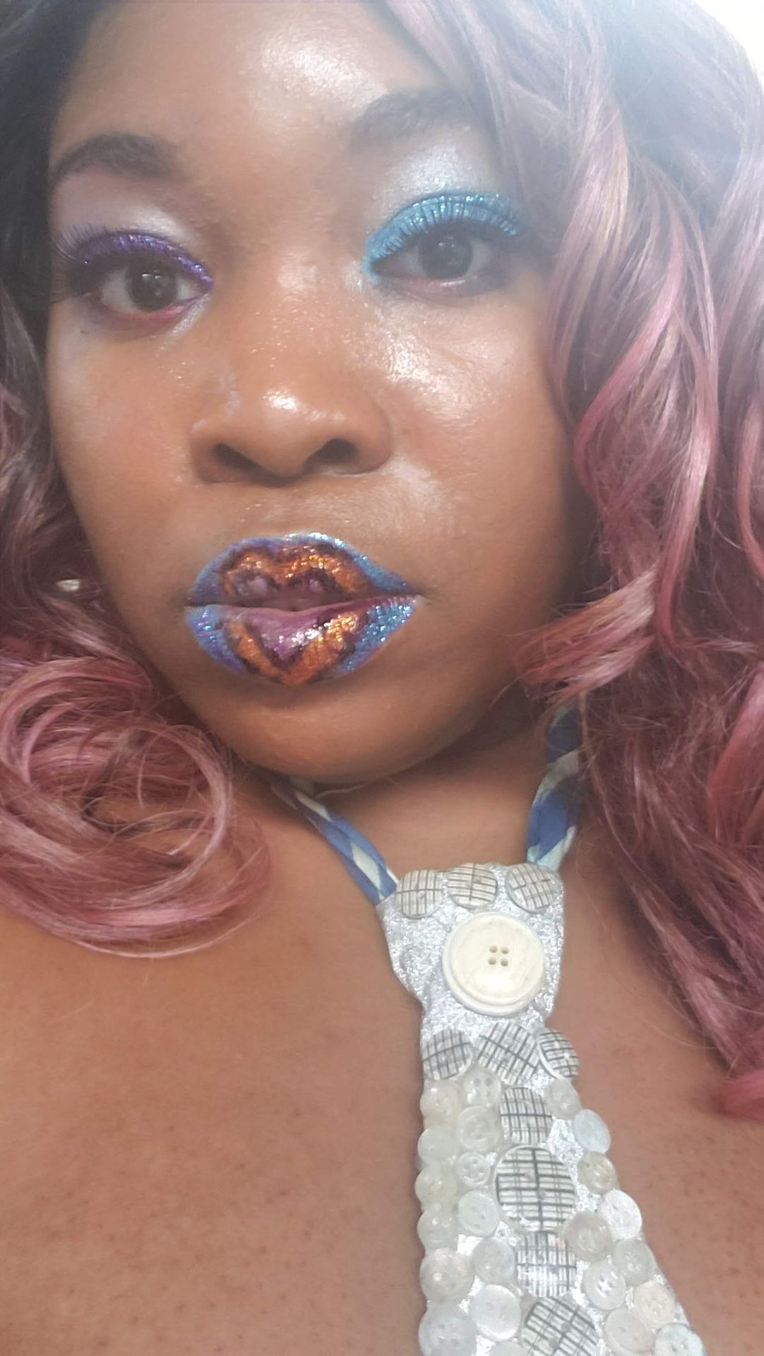 Close-up of multicolor gemstone lips with rose-toned curls