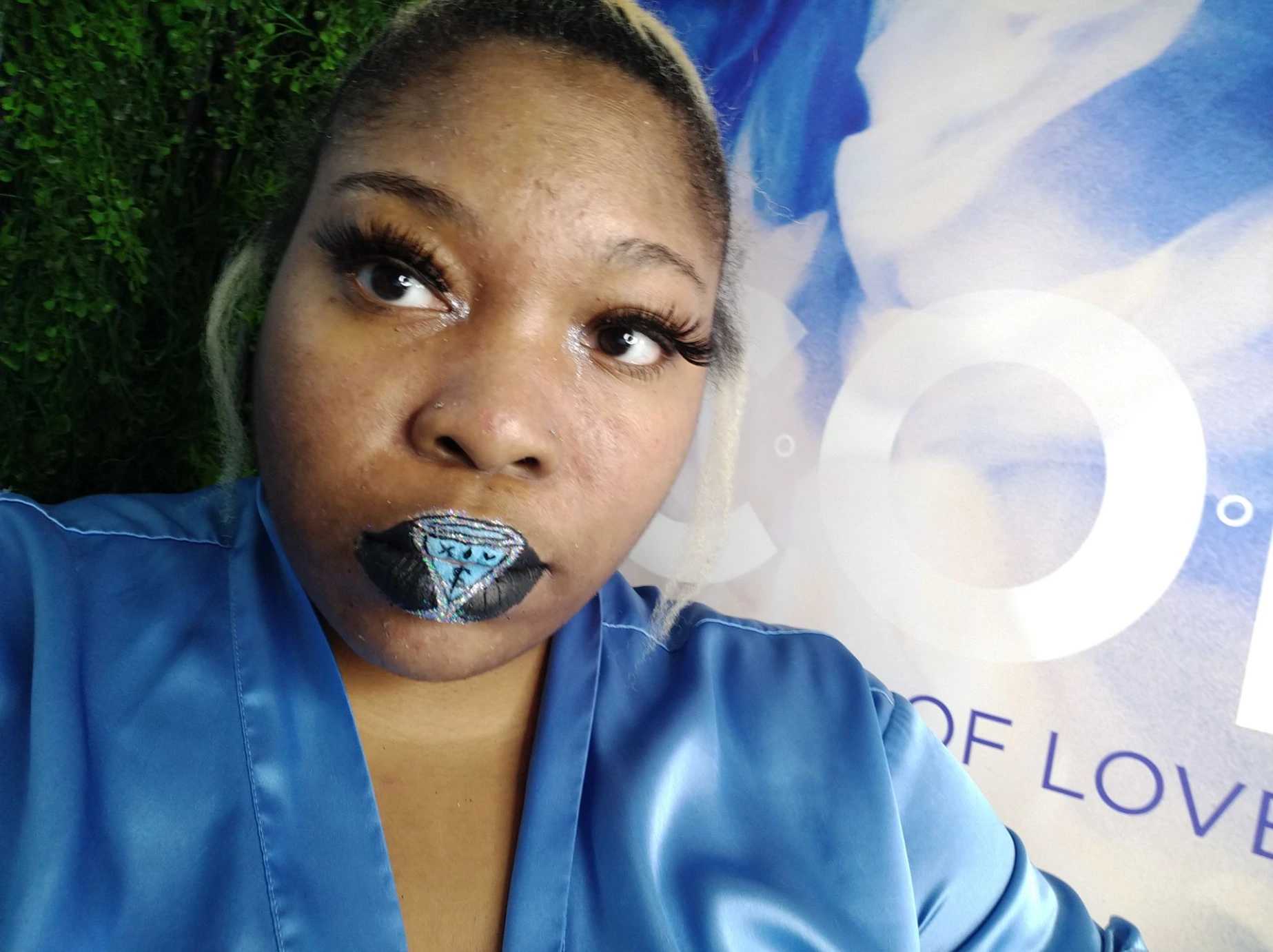 Woman in denim jacket wearing midnight blue metallic lipstick