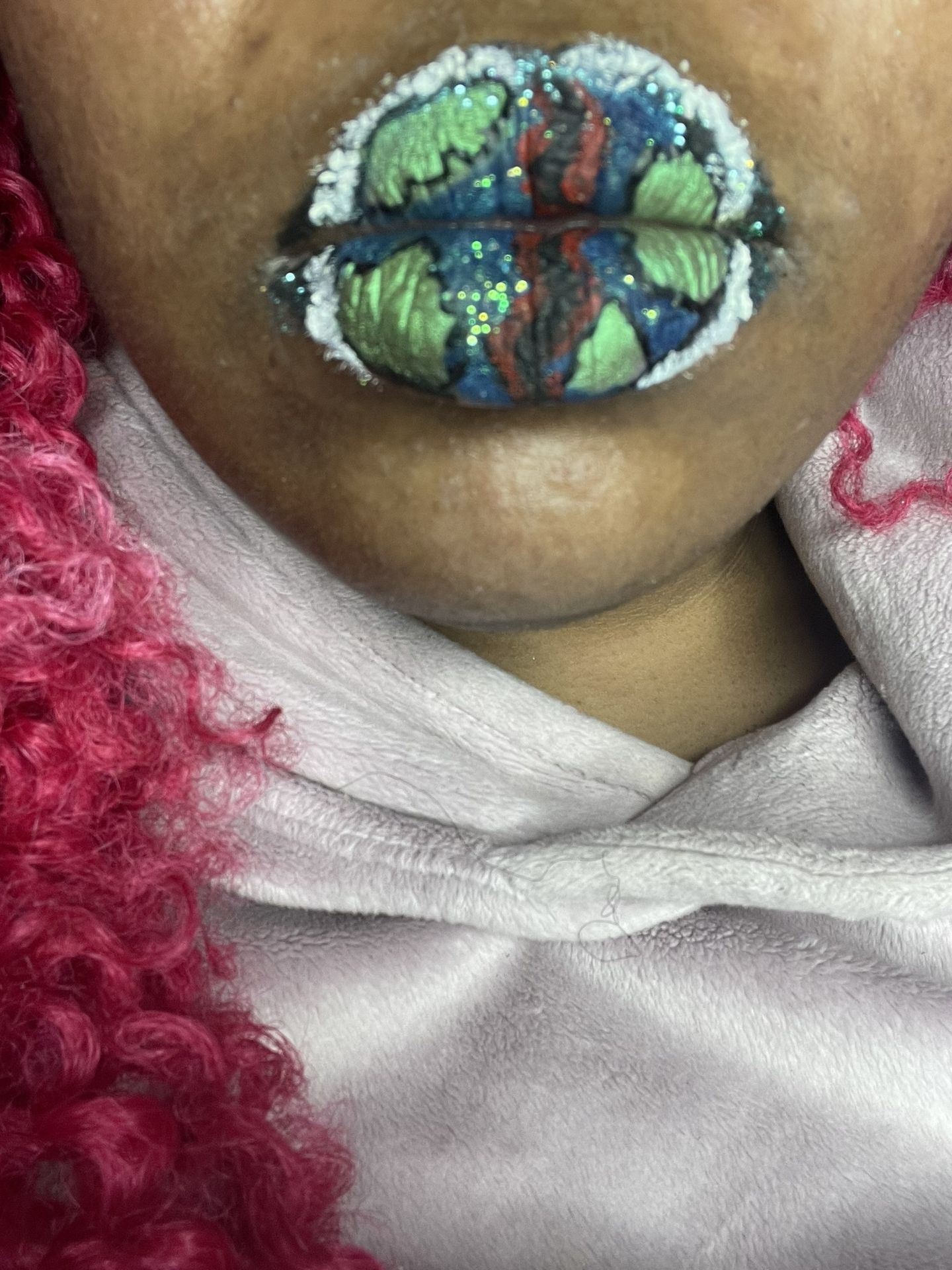 Close-up of rainbow foil lips against beige sweater
