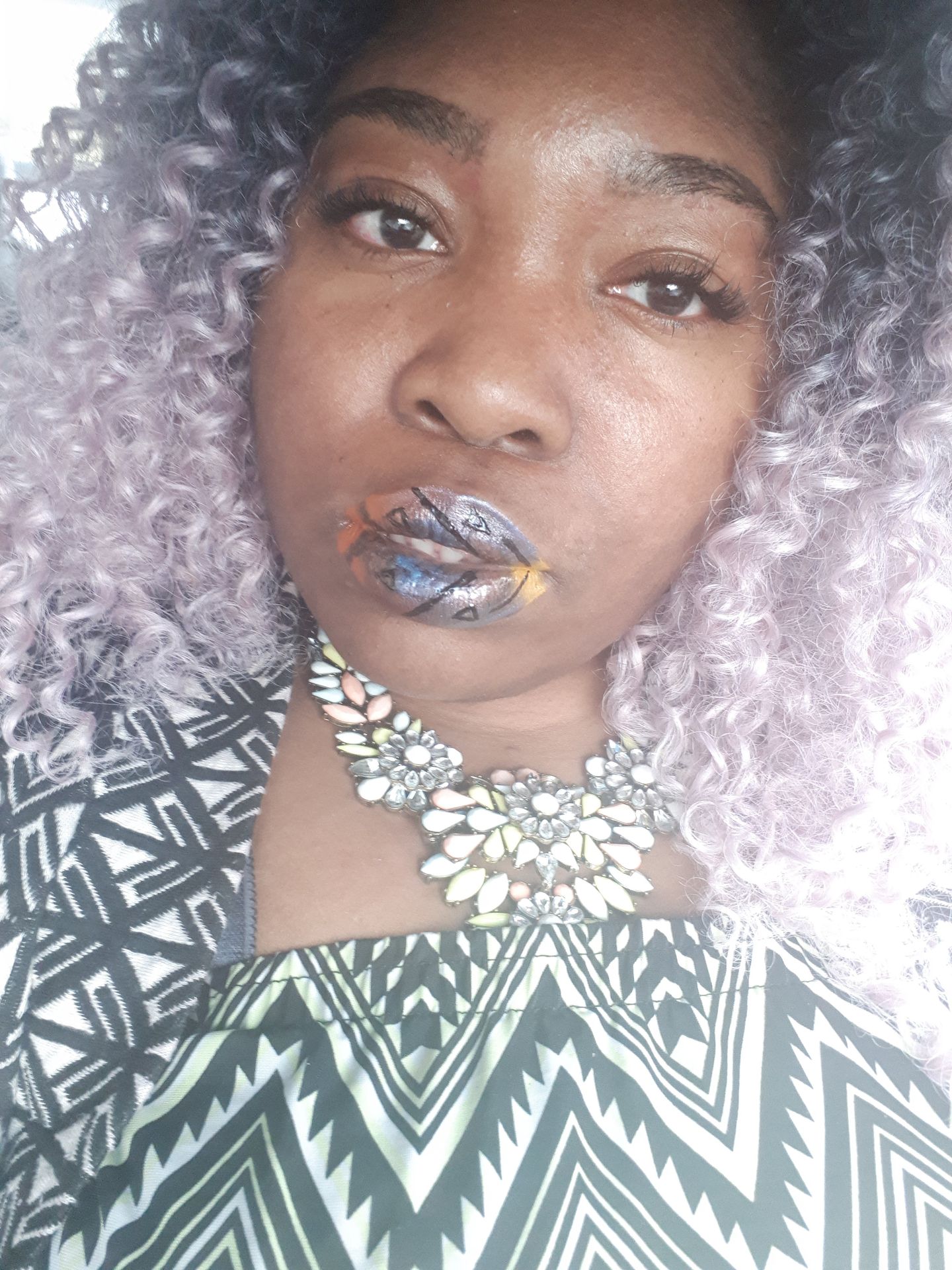 Woman with silver curls wearing icy blue metallic lipstick
