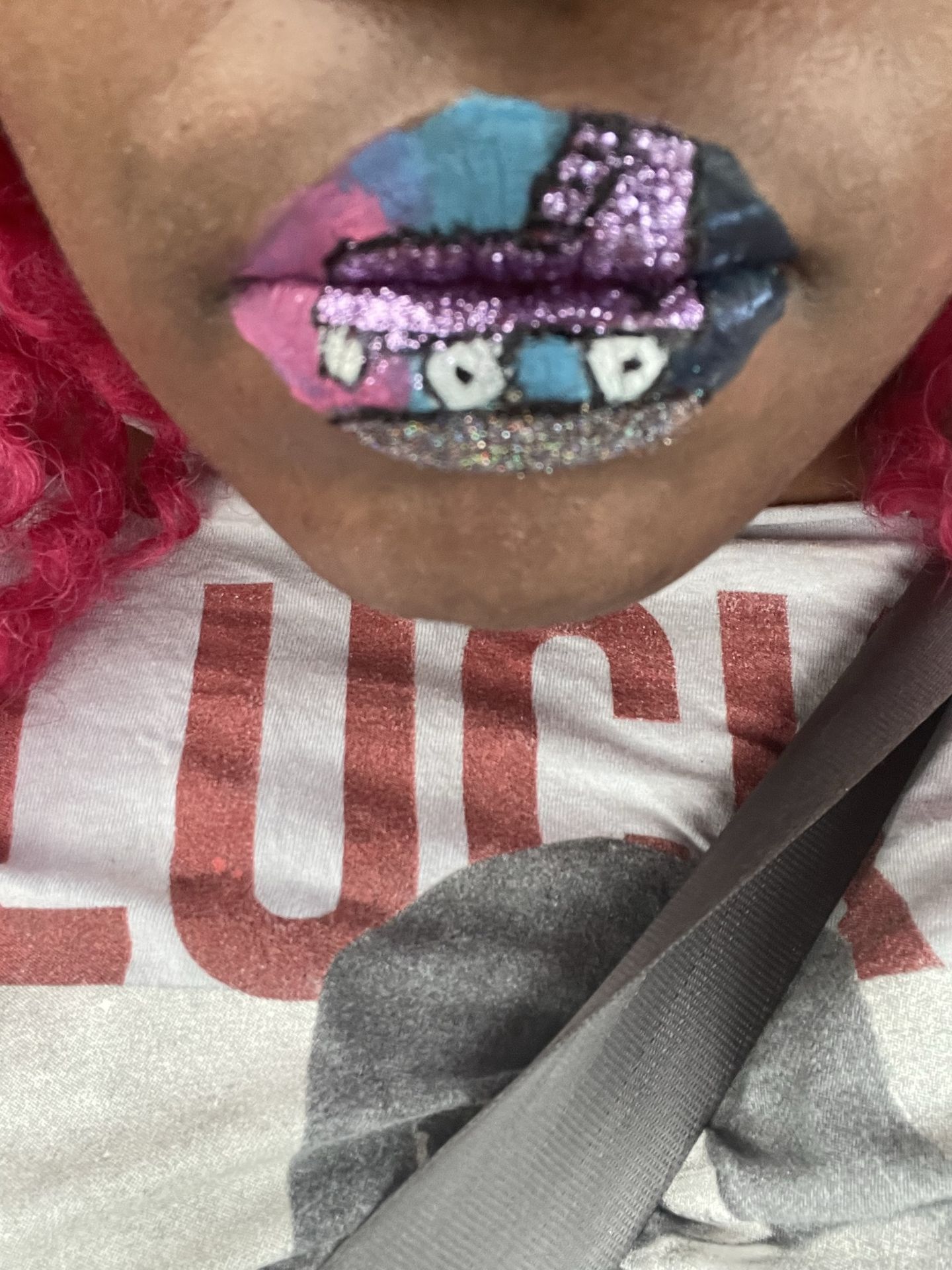 Close-up of deep berry lipstick with layered glitter accents