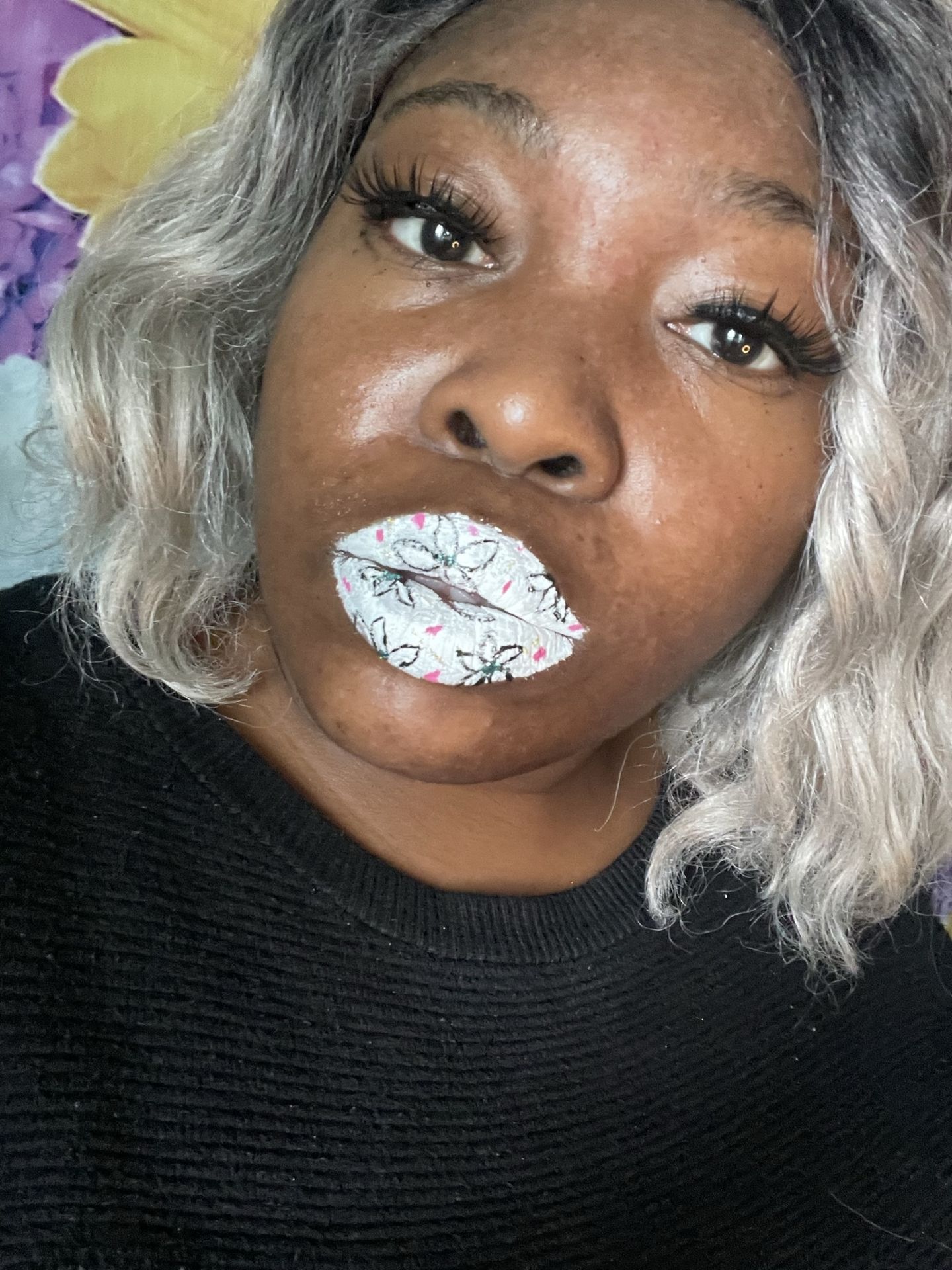 Woman with silver curls and pearl-white crystal lip centerpiece