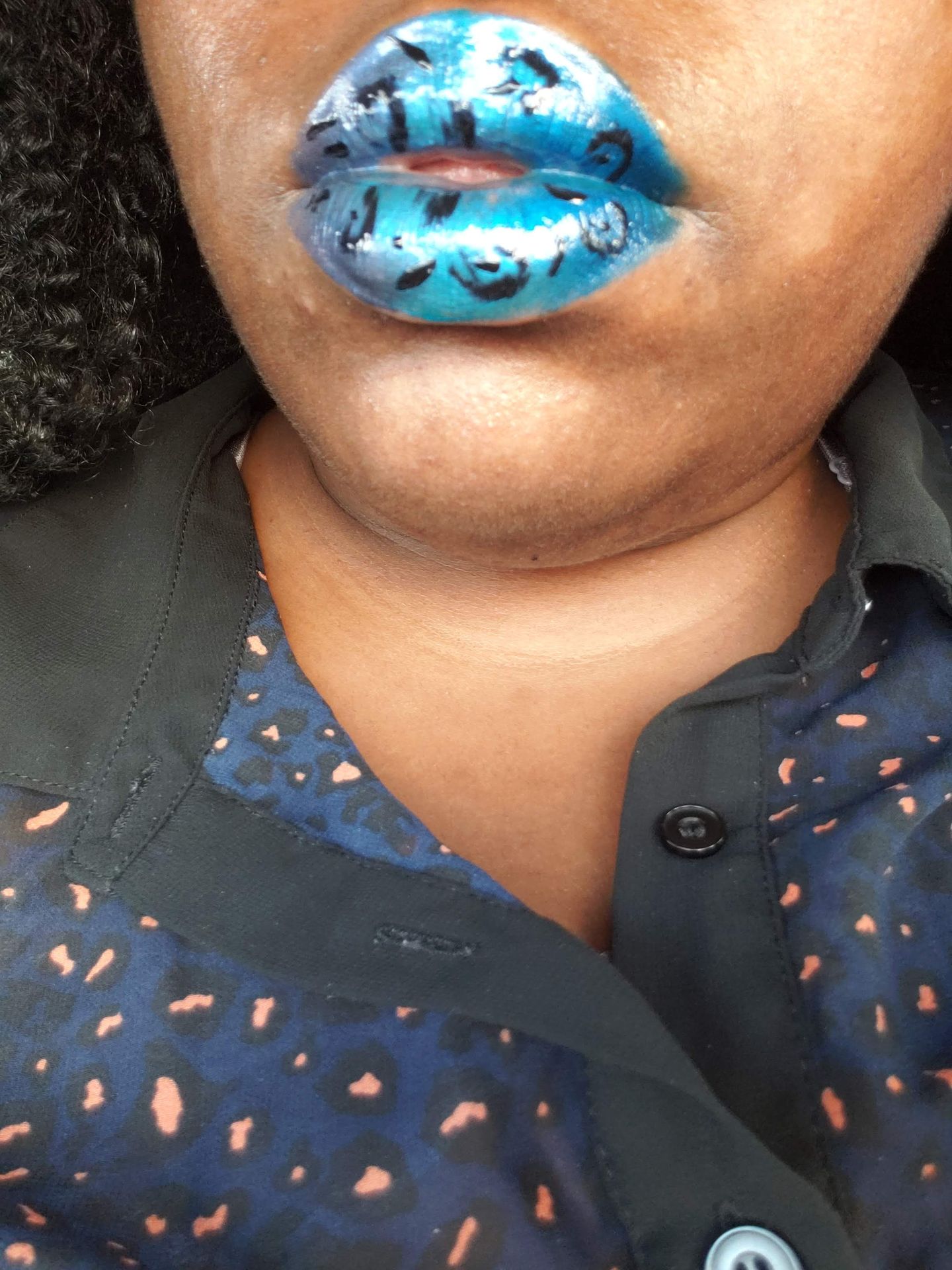 Close-up of teal metallic lipstick with subtle shimmer