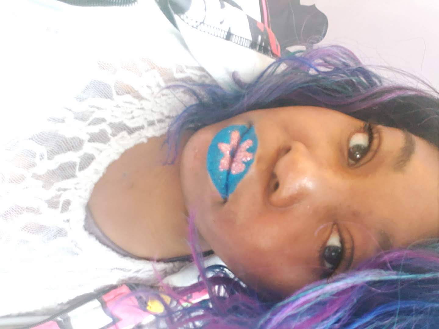 Woman with lavender curls and pastel rainbow lip art