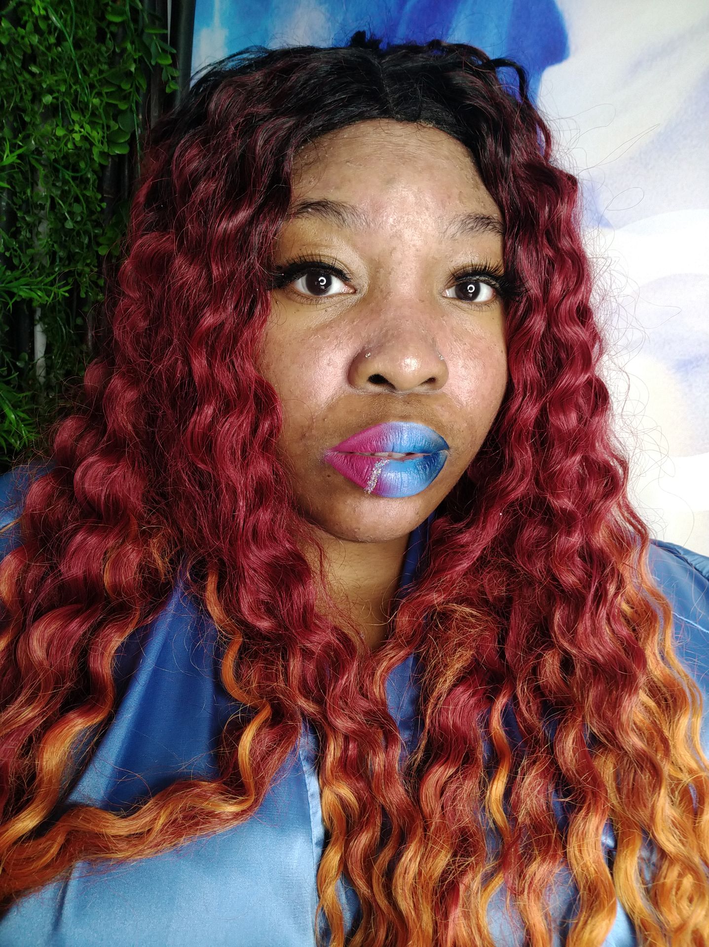 Black woman with short natural hair and gold foil lip art, high-detail macro beauty shot.