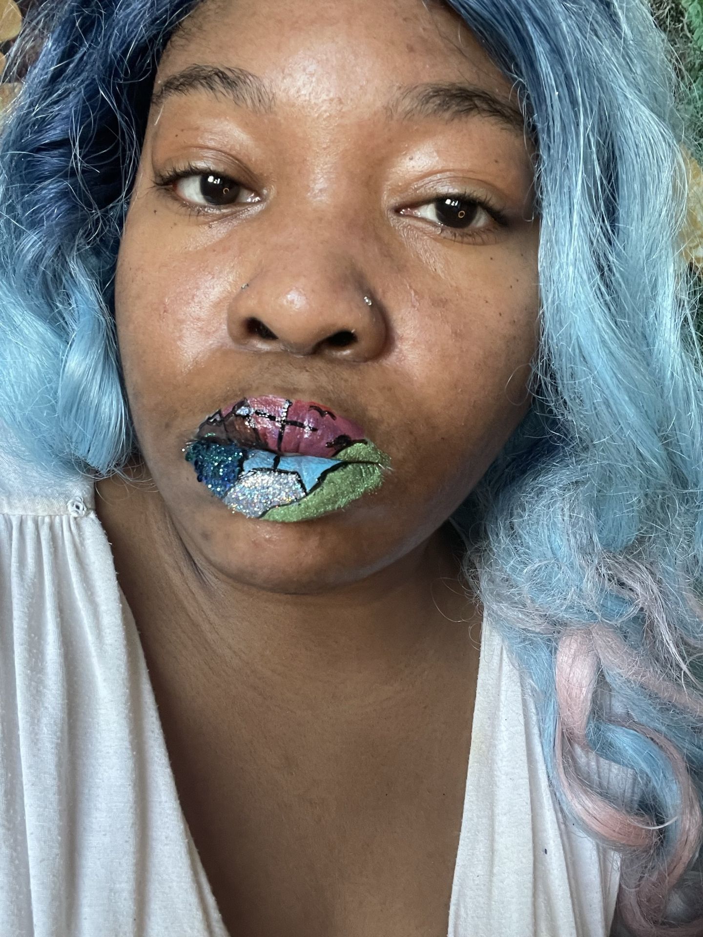 Woman with silver-blue hair and teal metallic lip color