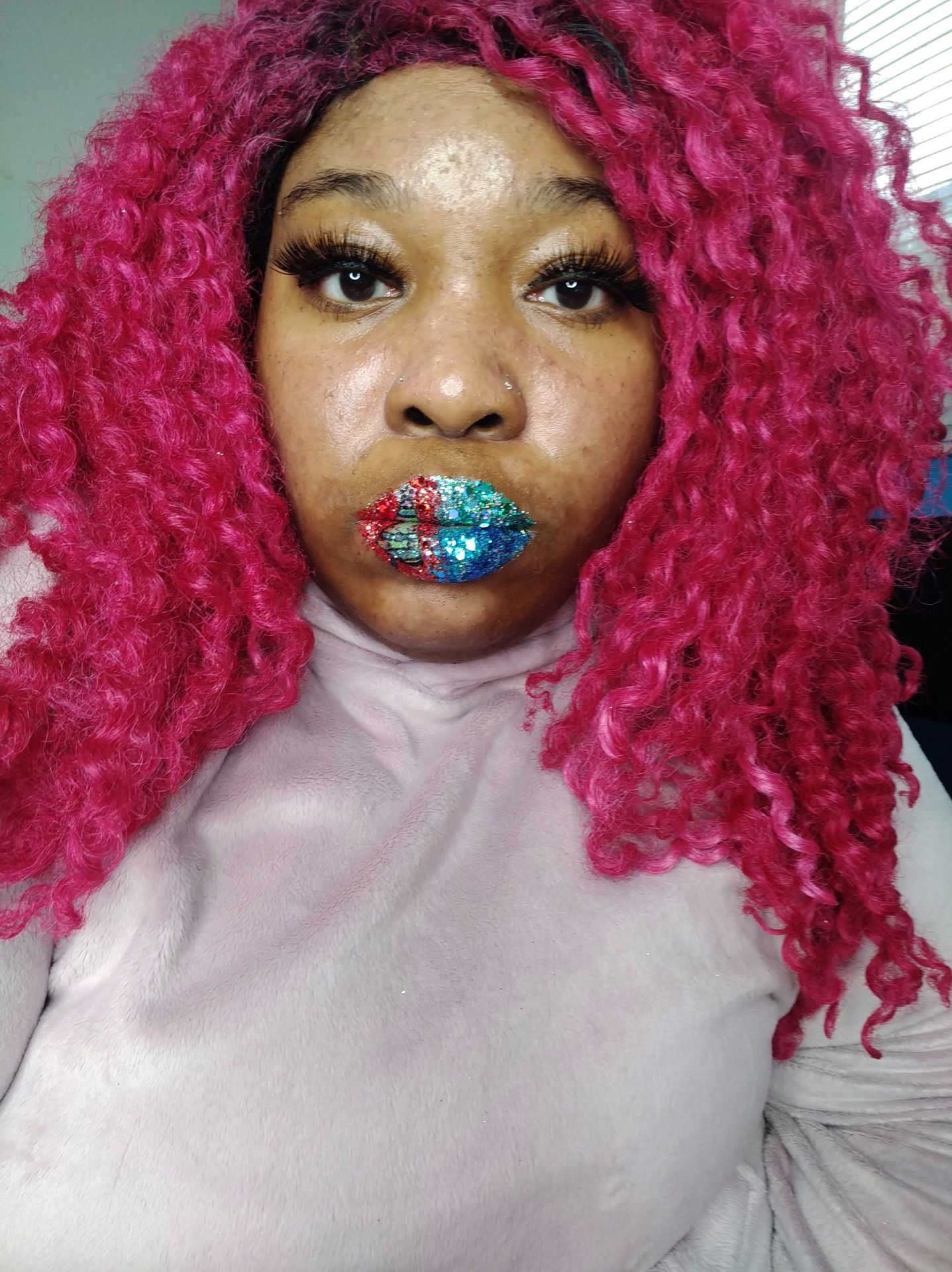 Woman with fuchsia curls and multicolor glitter mosaic lips