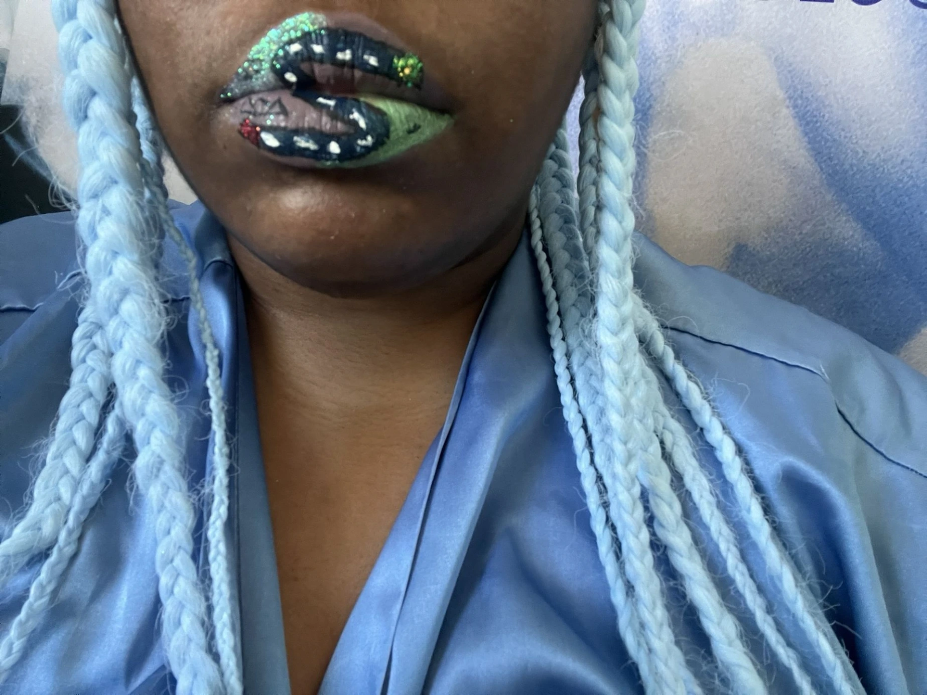 Woman with sky-blue braids and emerald-flecked metallic lips