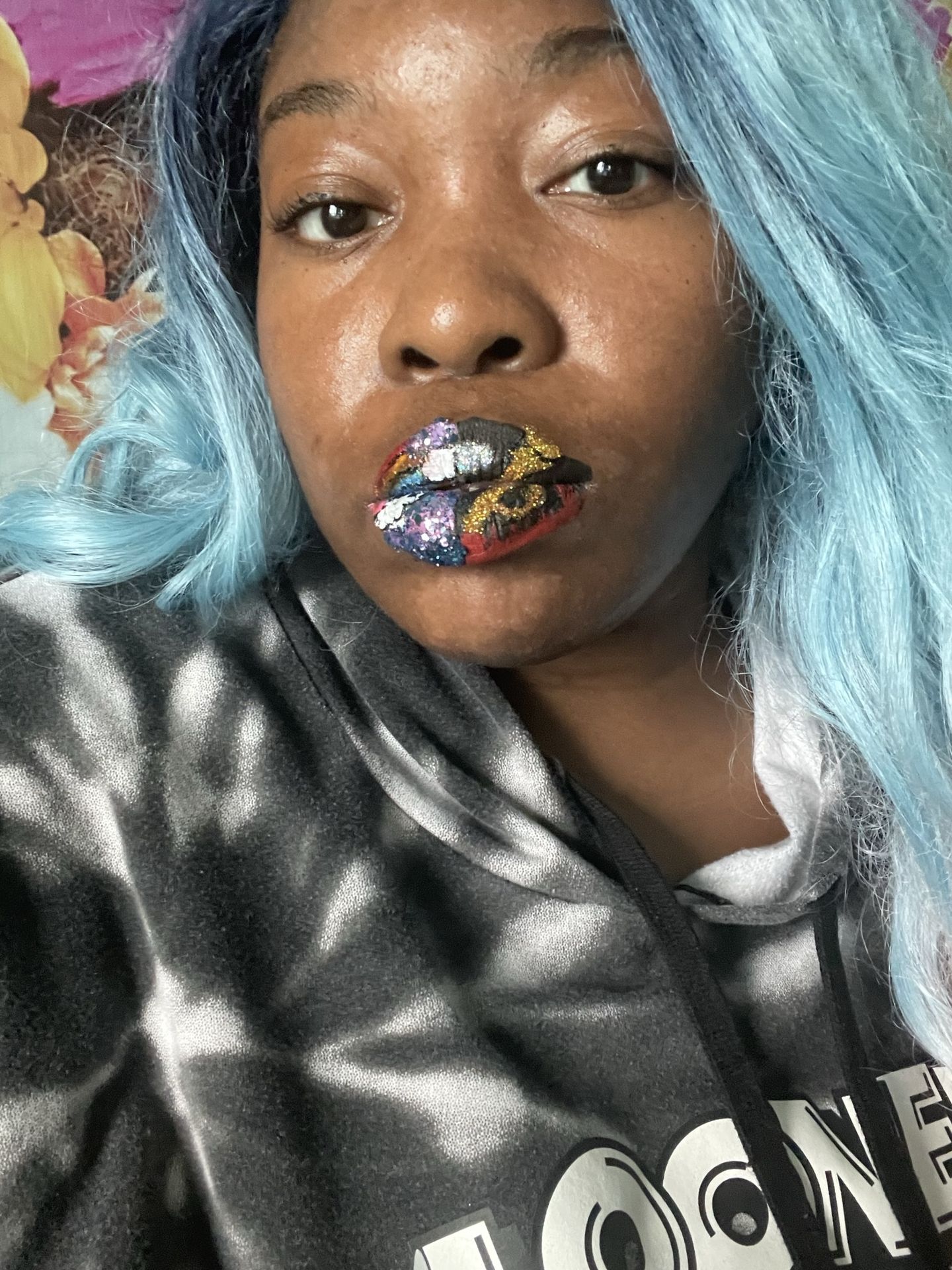 Woman in black-and-white scarf wearing copper foil lip art