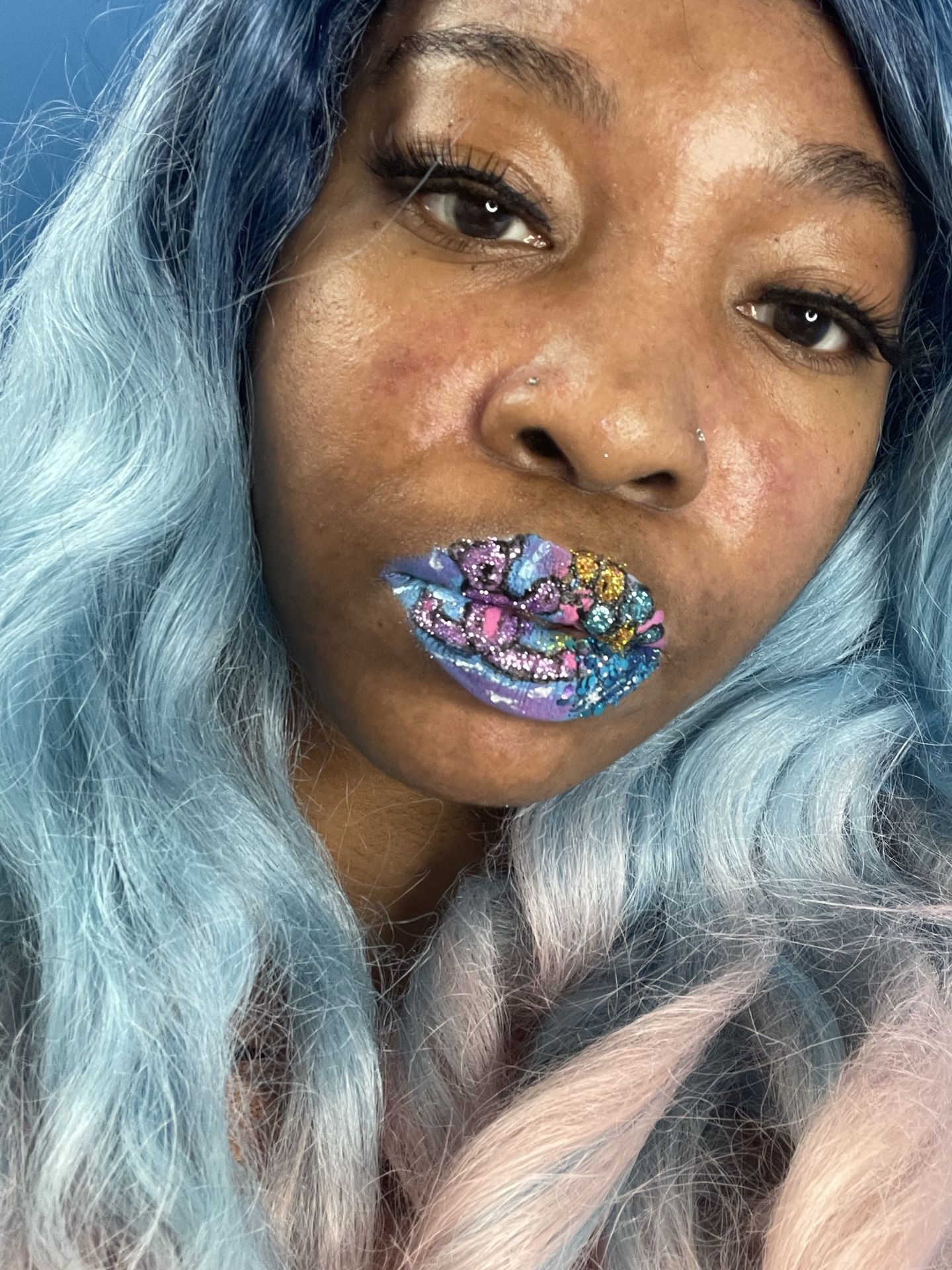 Woman with pale blue hair and layered sapphire glitter lips