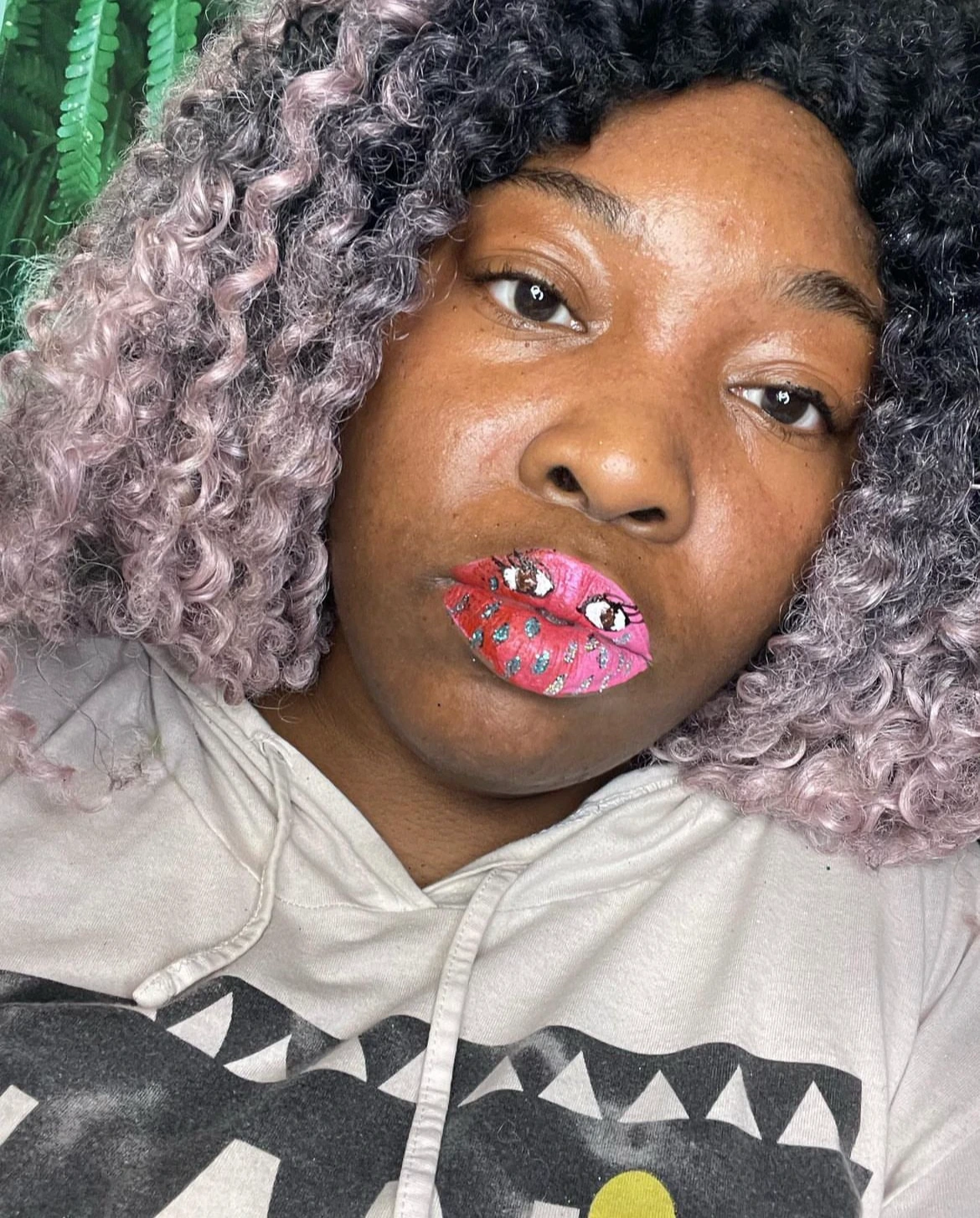 Black woman with metallic blue and gold glitter lips