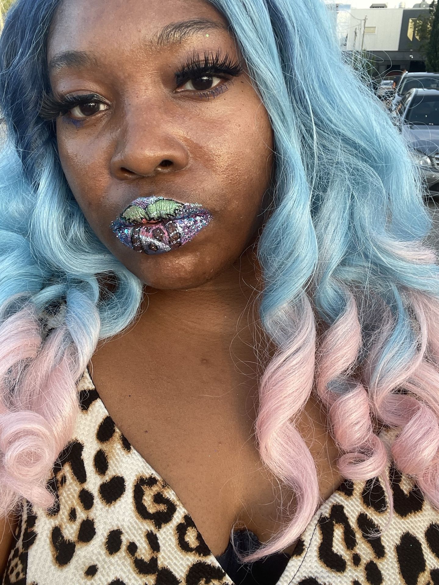 Black woman with purple curls and blue metallic lips, dramatic portrait with reflective textures.