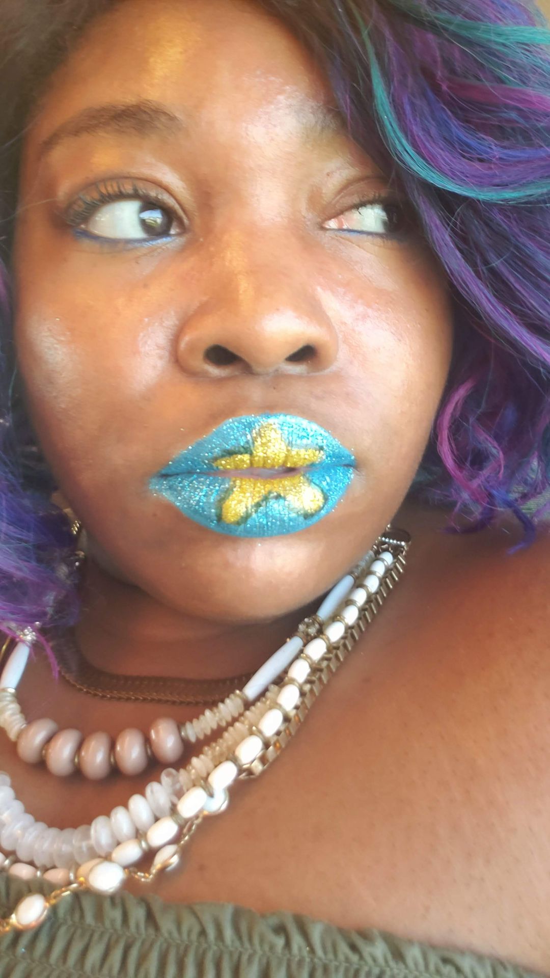Woman with violet hair and blue-gold metallic lipstick