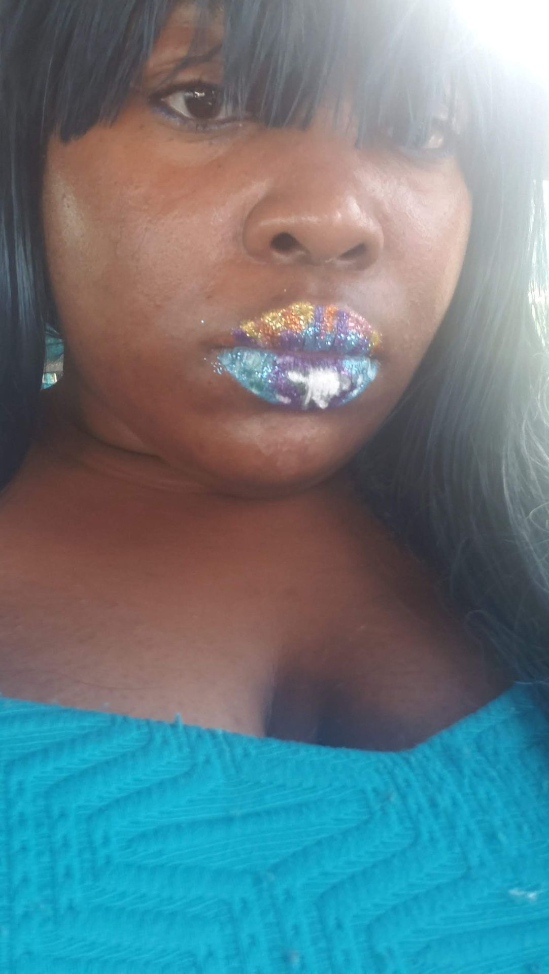 Black woman with glossy silver rhinestone lip design