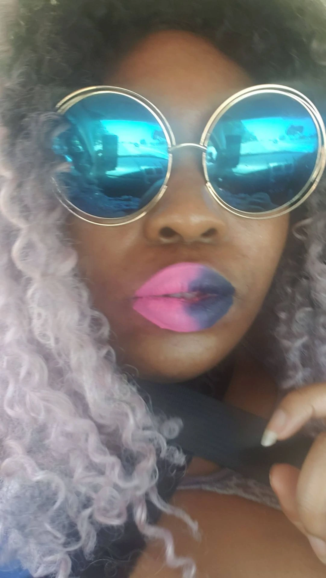Black woman wearing sunglasses and hot pink matte lipstick