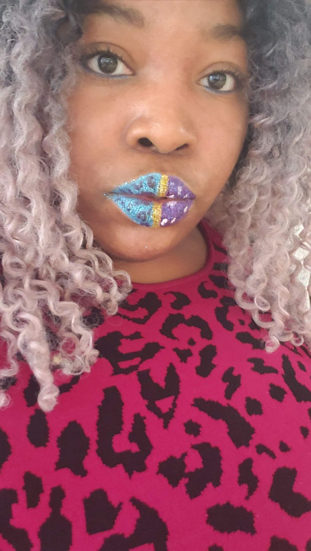 Woman with silver curls wearing sky-blue rhinestone lip design