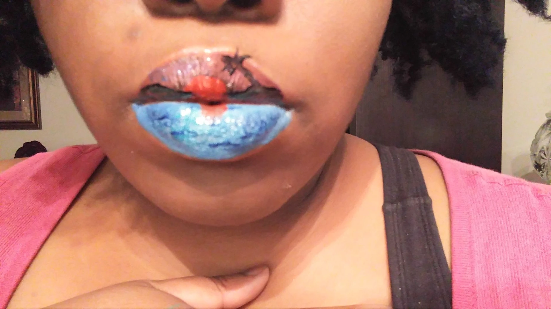 Close-up of lips painted in sky blue with a coral center highlight