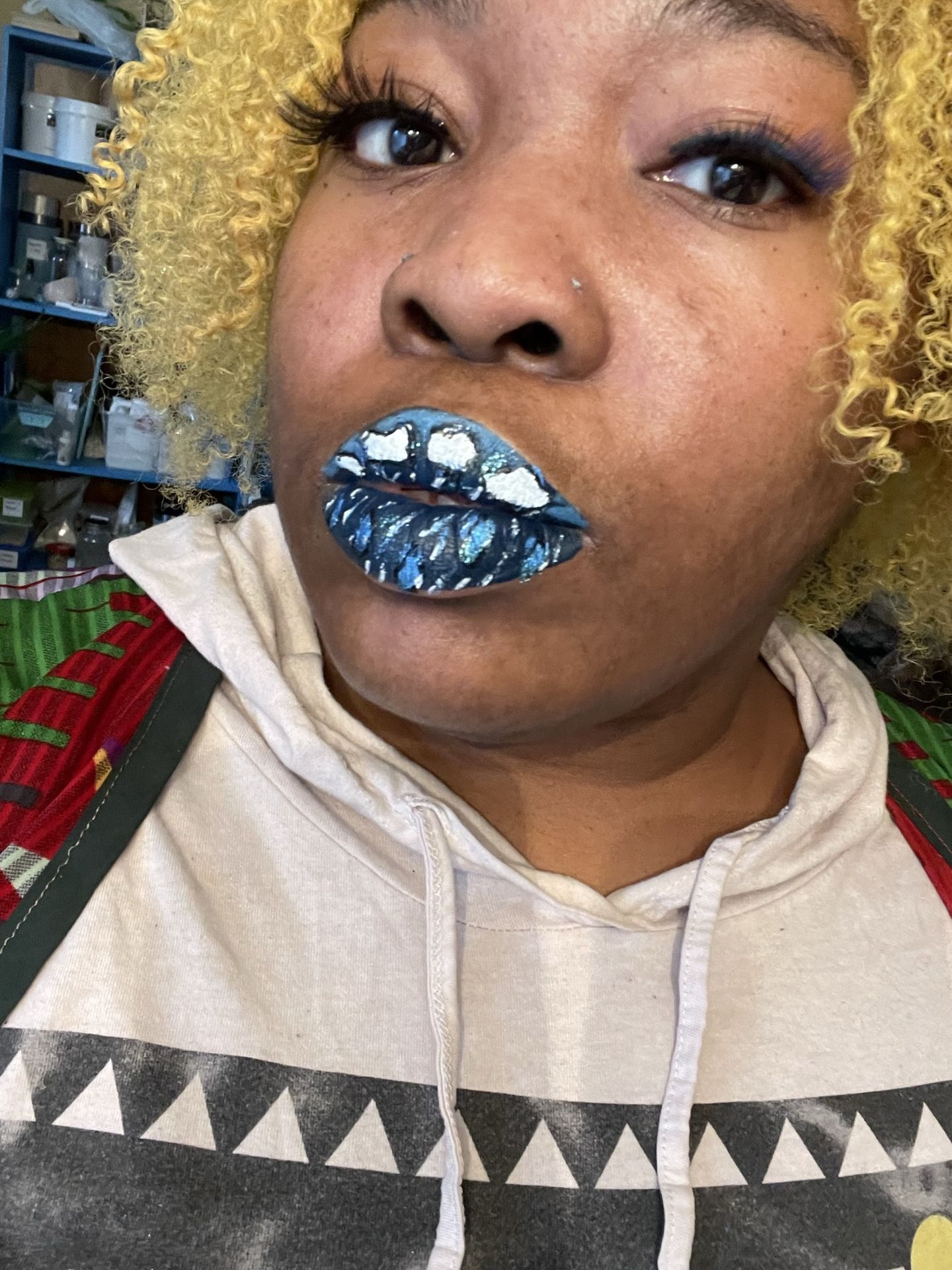 Woman in beige hoodie wearing deep sapphire metallic lipstick