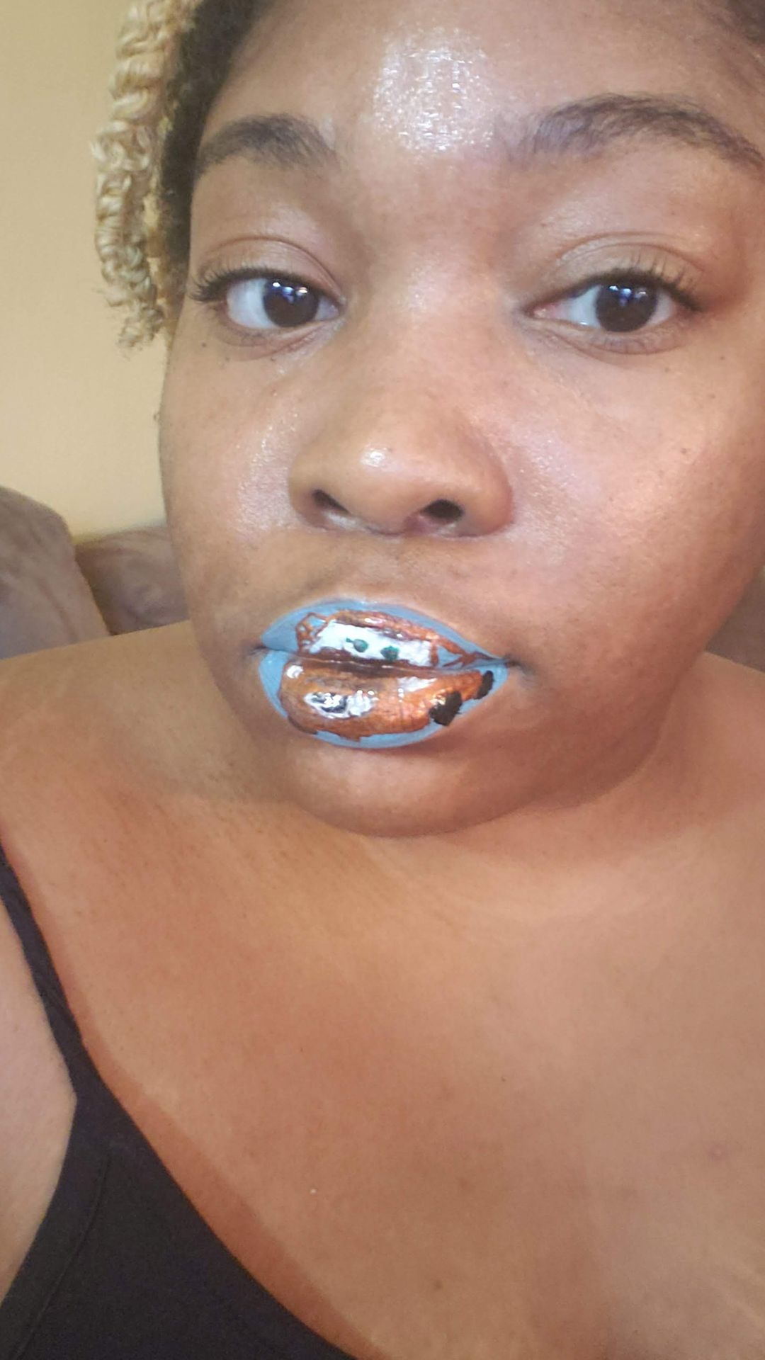 Black woman with bare shoulders and silver crystal lip centerpiece