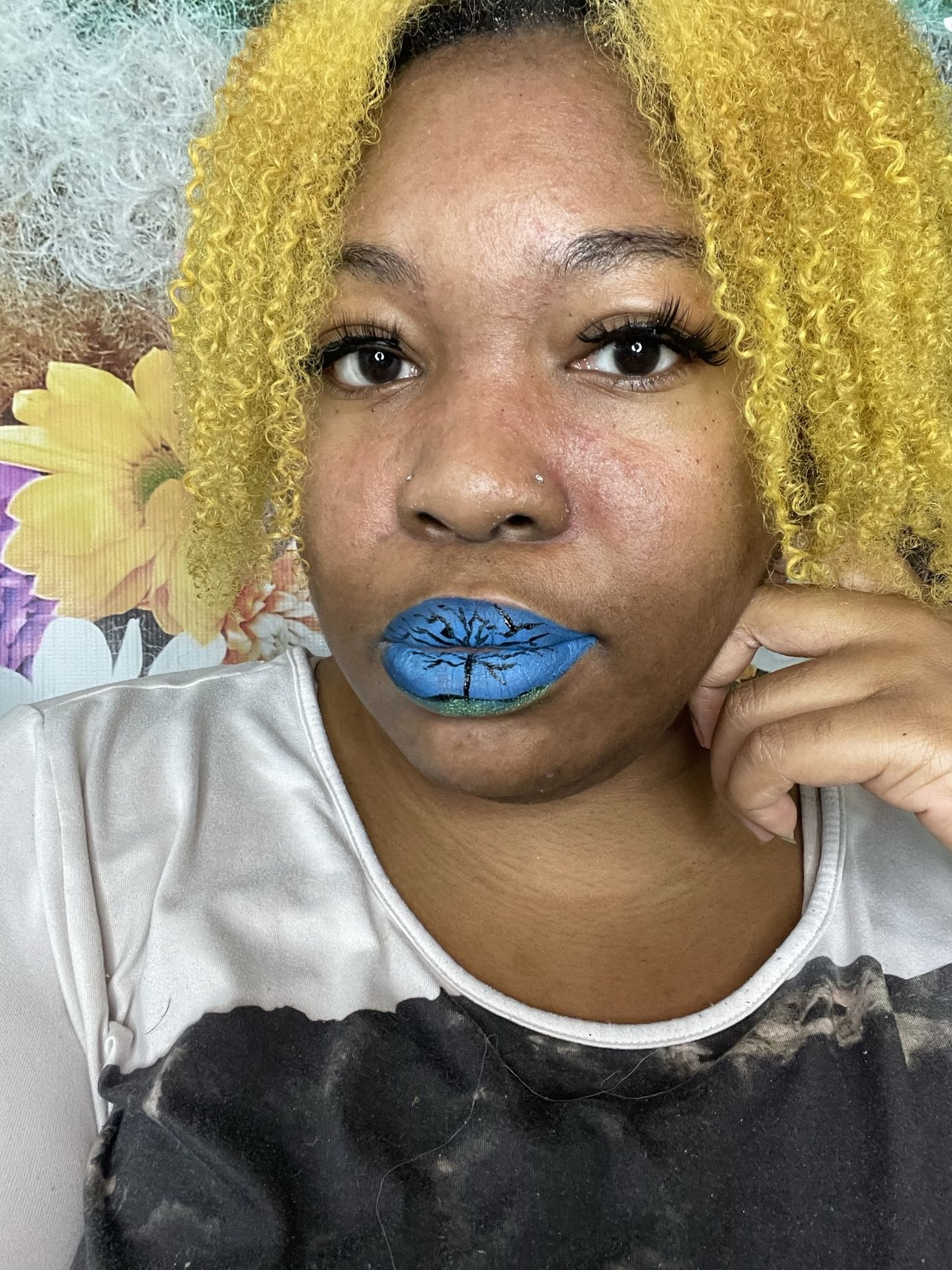 Woman with golden curls wearing matte sky-blue lipstick