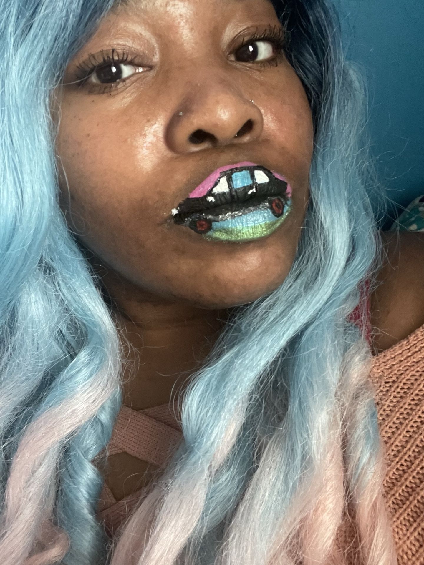 Woman with pale blue hair wearing emerald and silver crystal lip art