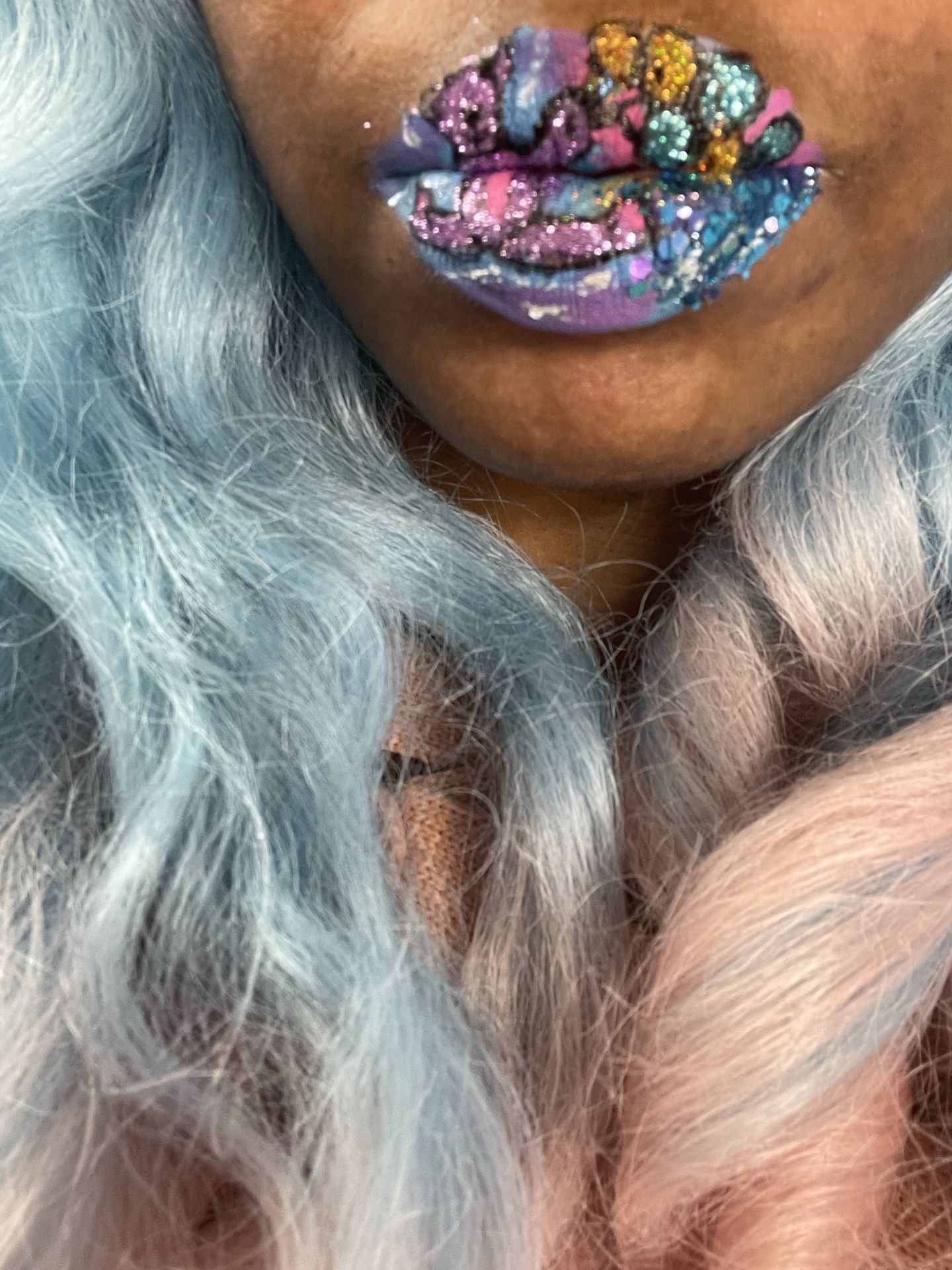 Close-up of silver-blue curls and jewel-toned crystal lips