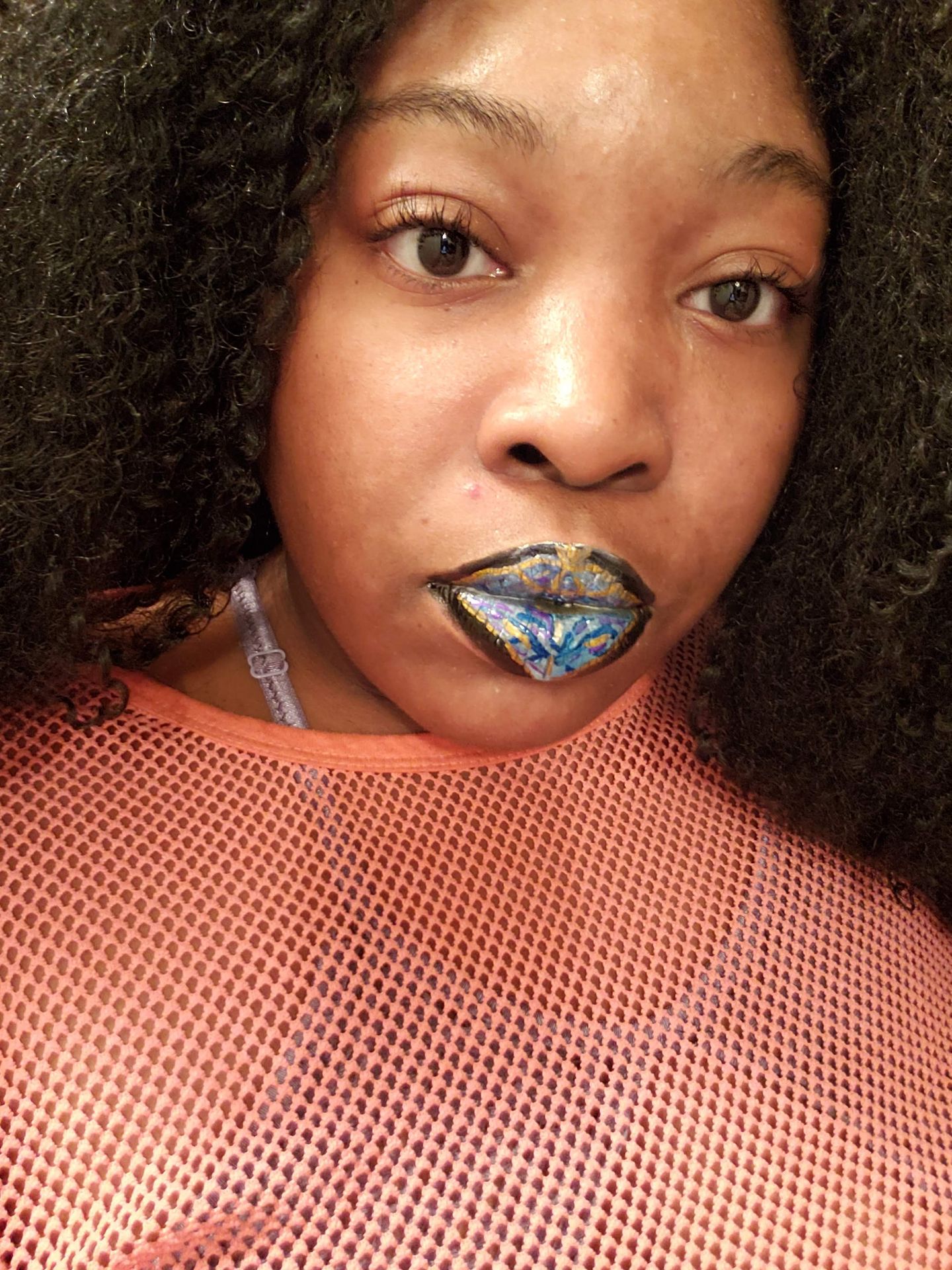 Woman in rust sweater with deep teal satin lipstick