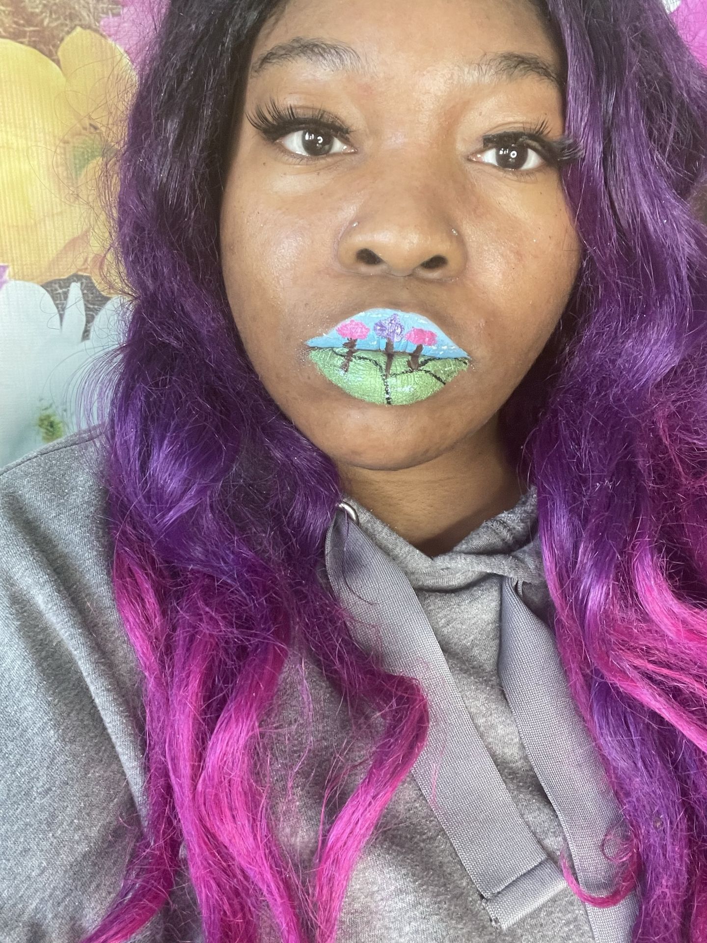 “Portrait of woman with purple and silver hair wearing green glitter lipstick.”