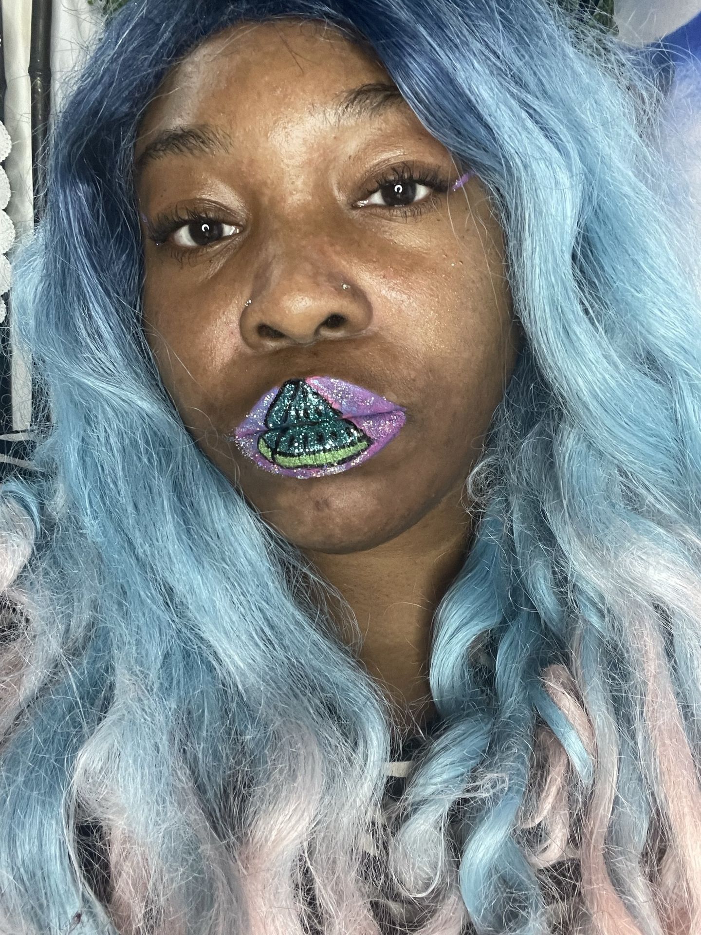 Woman with pale blue hair and lavender metallic lip finish